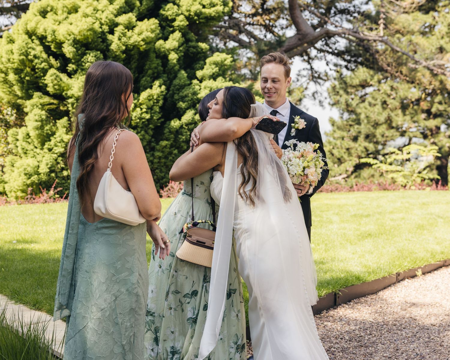 Guests watching an outdoor Cotswolds wedding ceremony in the gardens