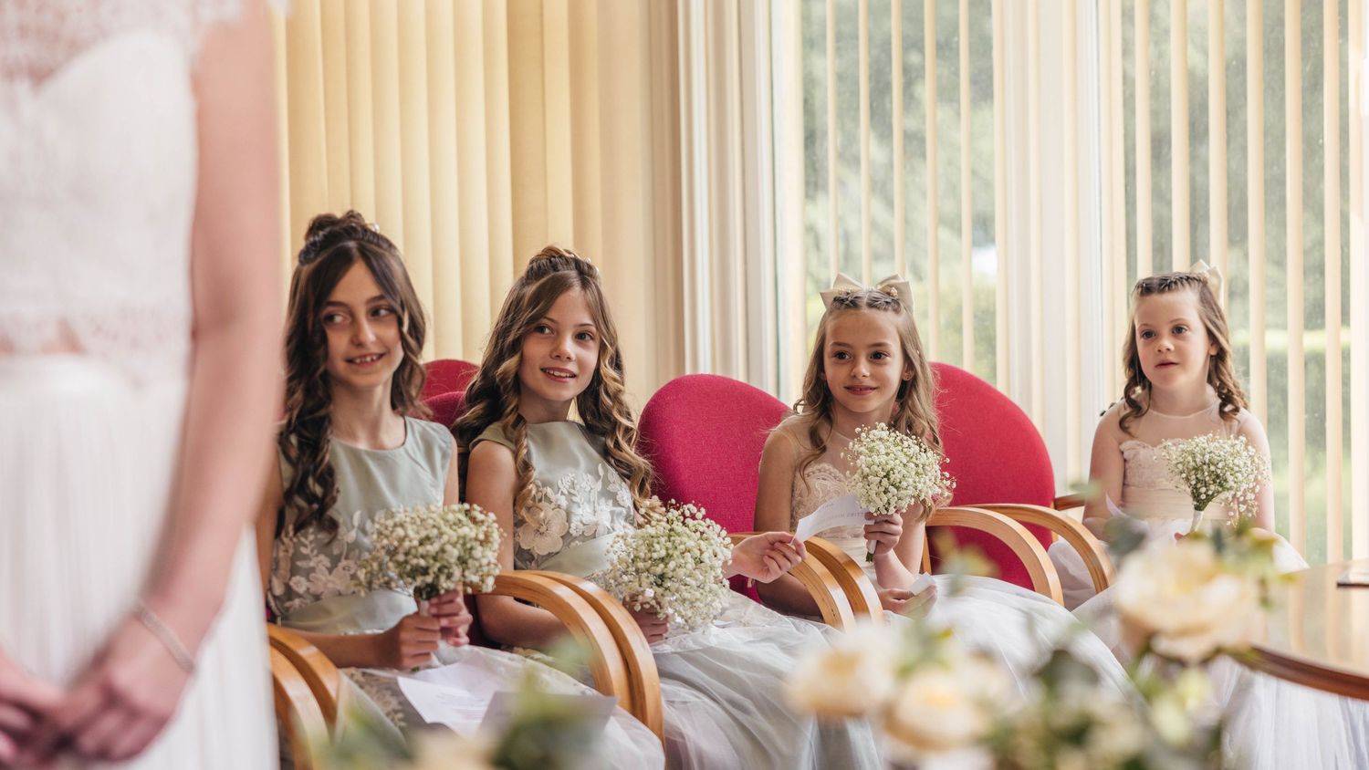 Bridesmaids watching their parents get married, captured by EvieSJPhotography.
