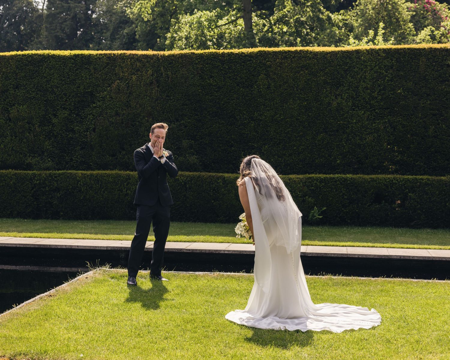 Bride and groom sharing their first look on their wedding day, captured in a relaxed documentary style by EvieSJPhotography.