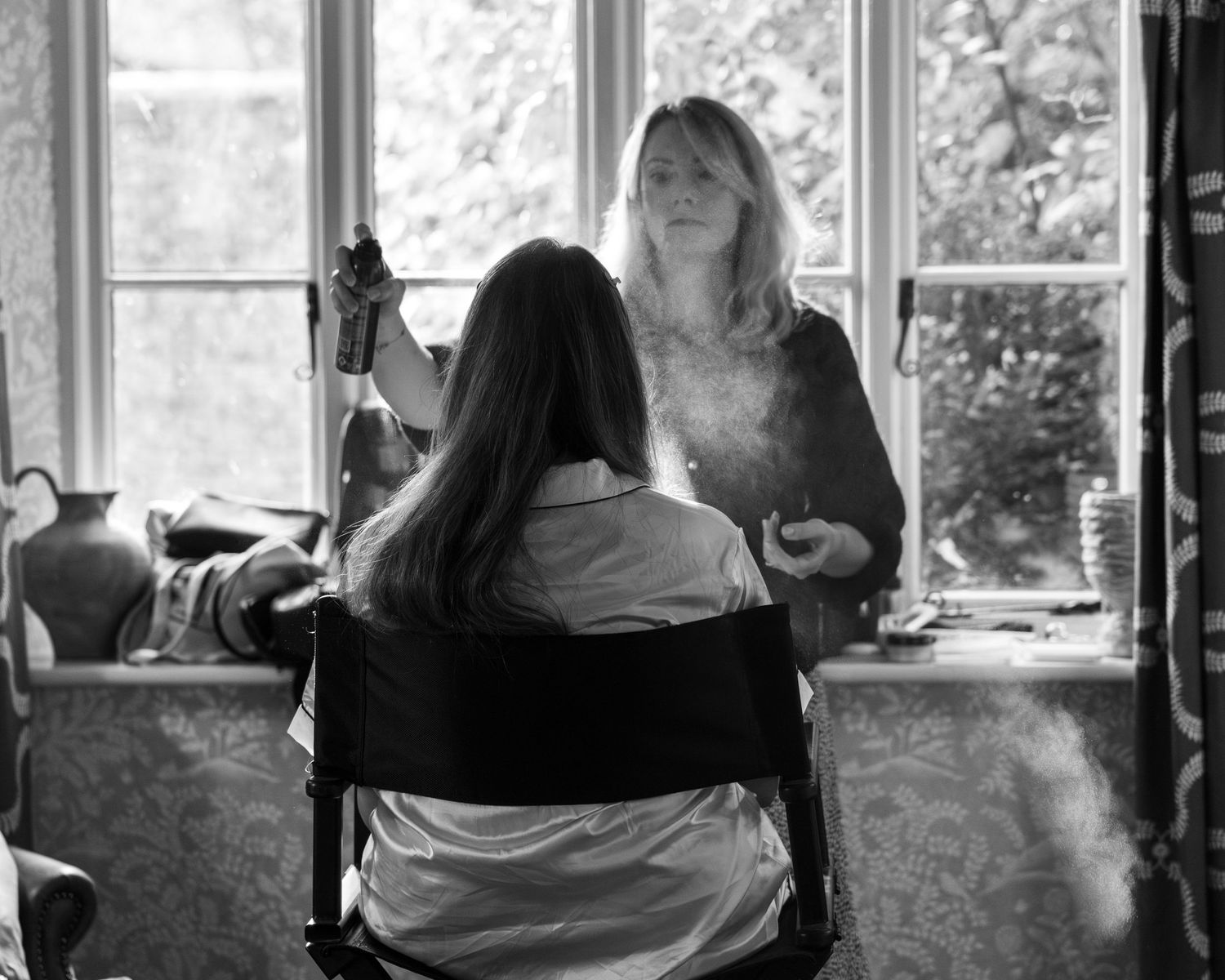 A bride having her makeup done during morning prep on her wedding day, captured by EvieSJPhotography.