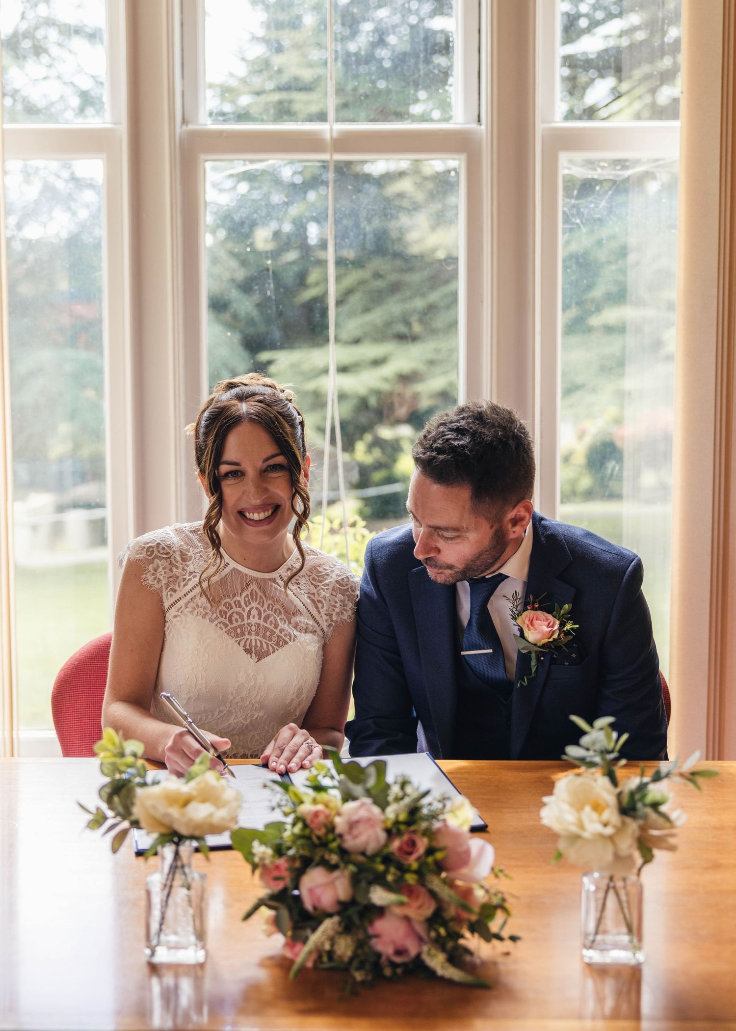 A bride and groom sharing a romantic moment during their ceremony, captured by EvieSJPhotography.