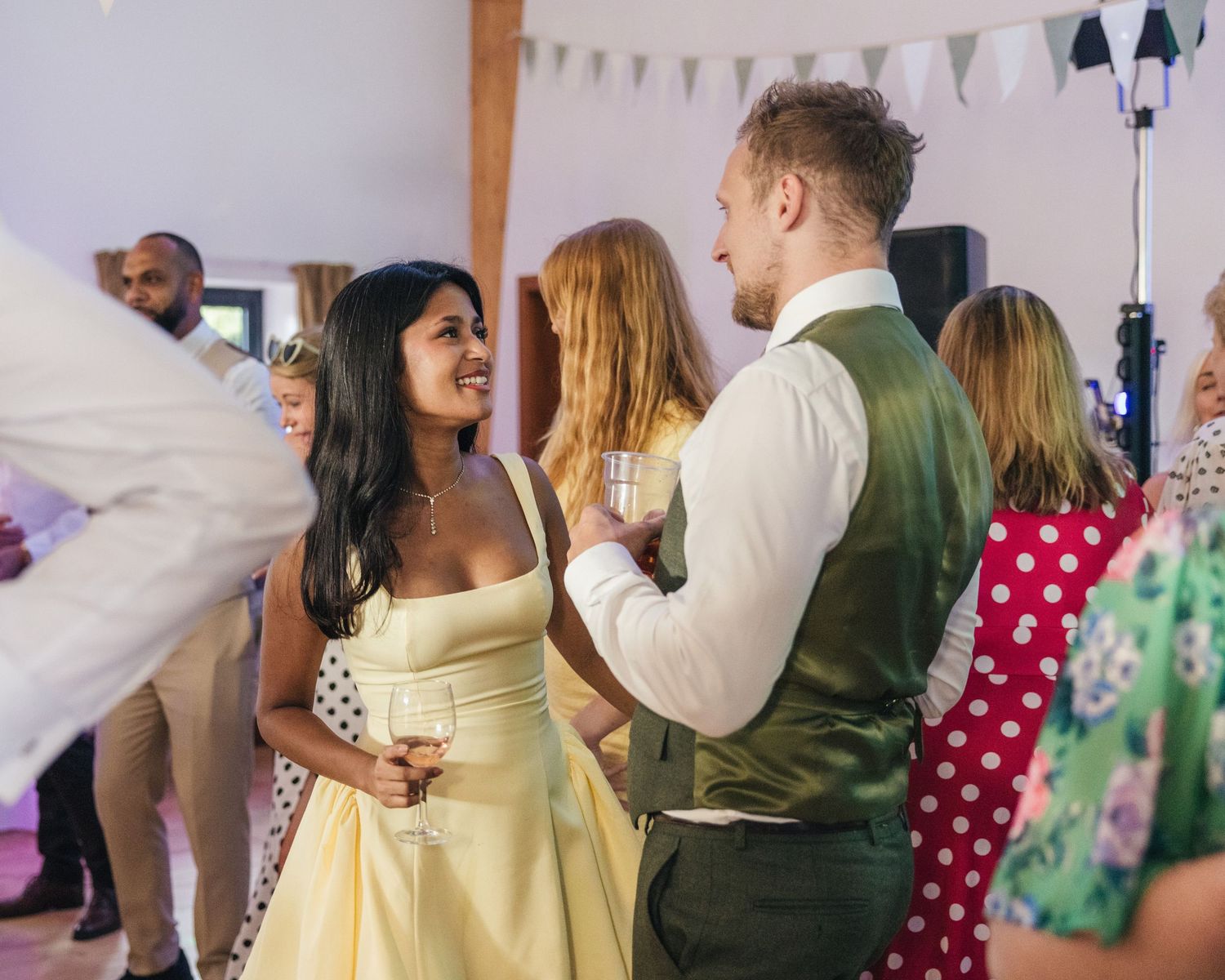 Two guests sharing a happy moment together on the dance floor at Rock Village Hall.