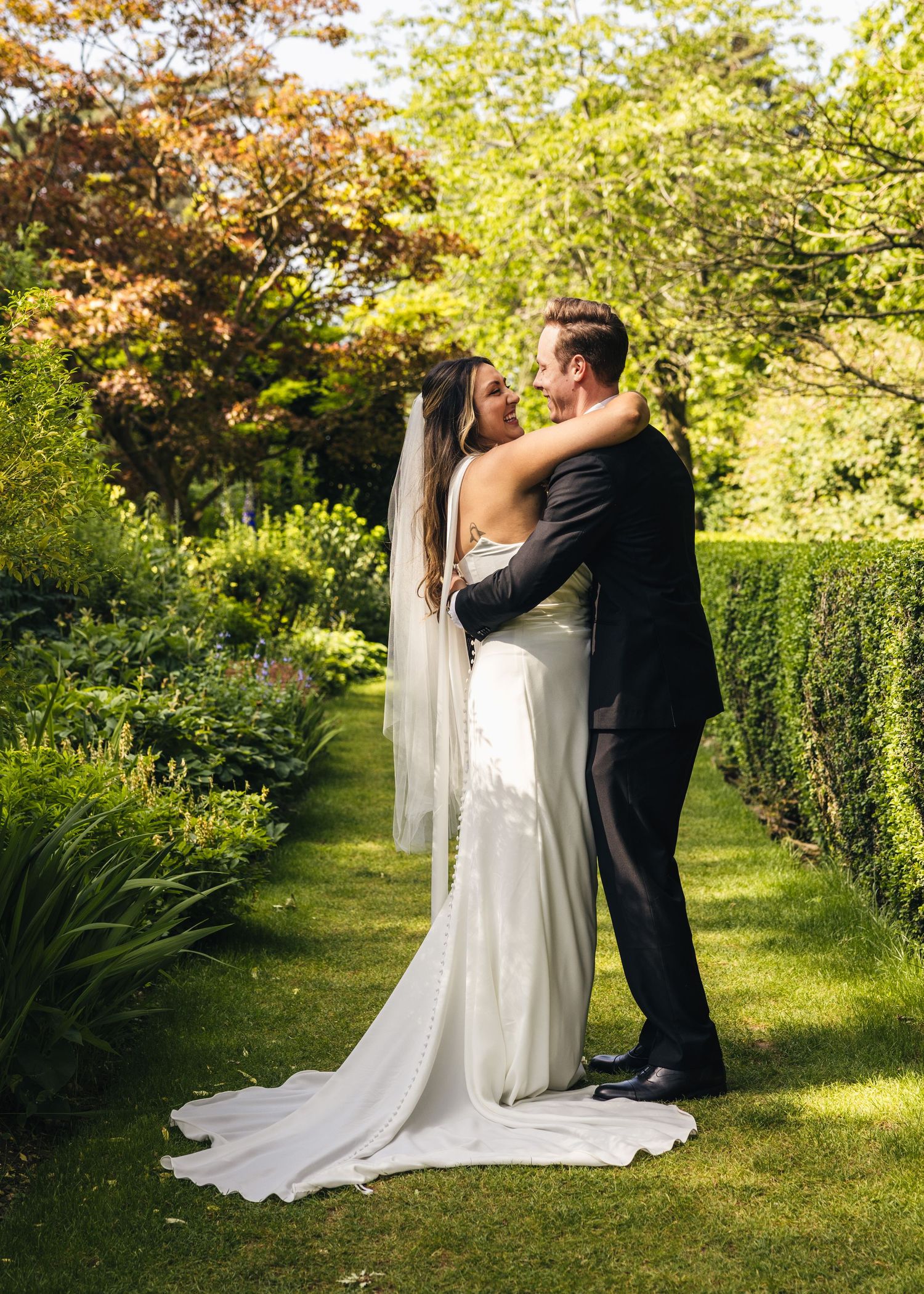 Bride and groom sharing private vows beneath the trees in the Cotswolds