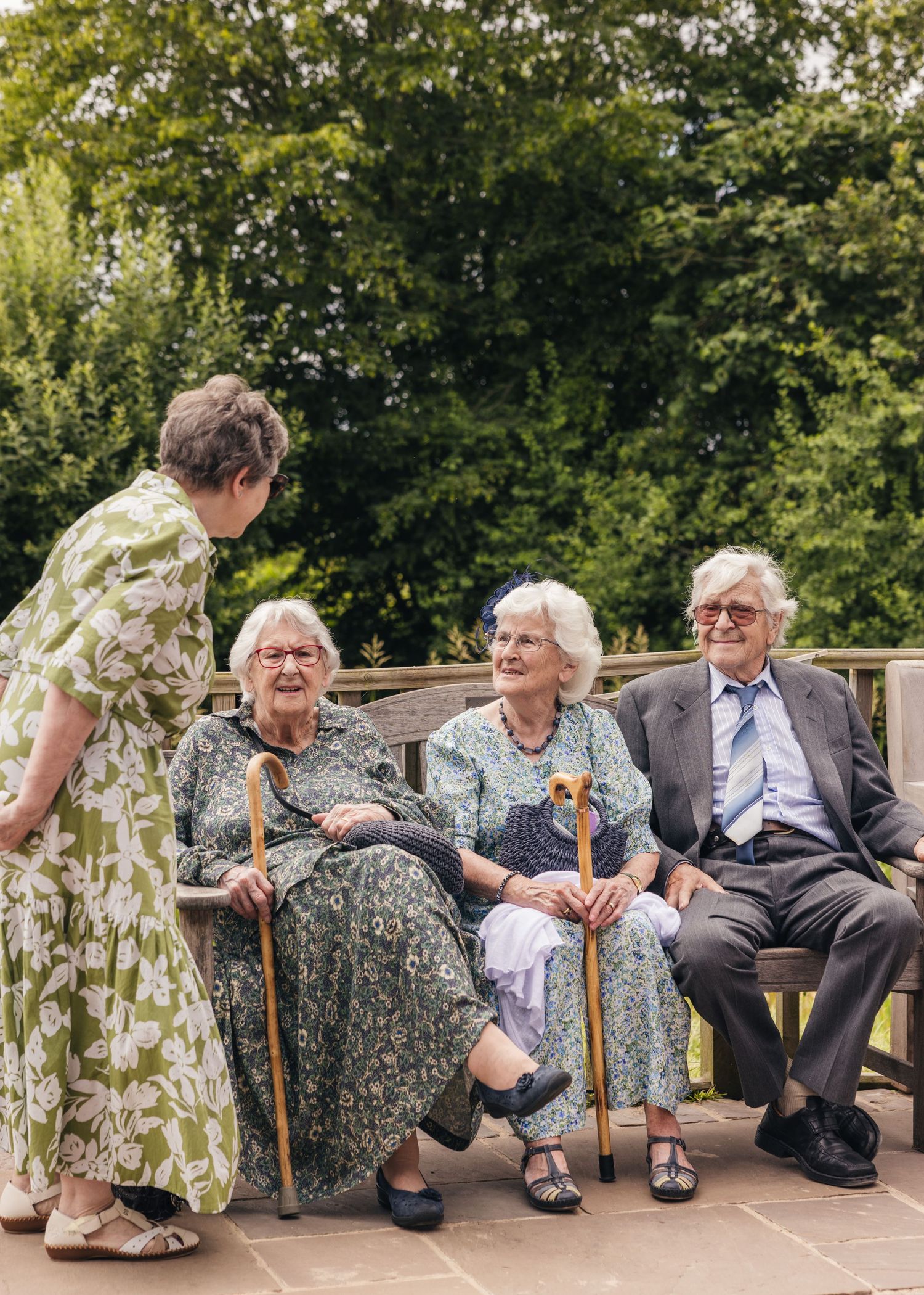Some older family members enjoying a catch up on a bench before the wedding starts.