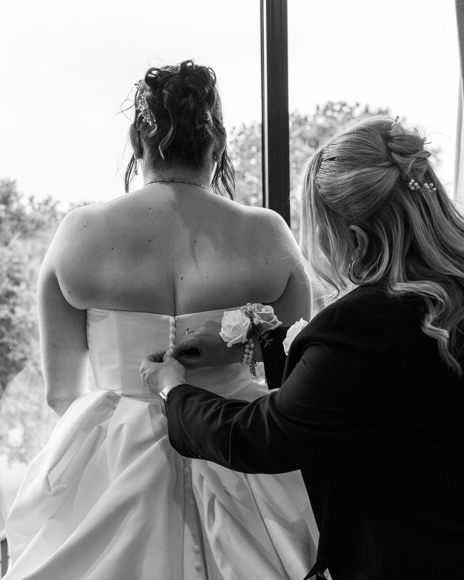 Emotional black-and-white photograph of Cortney sharing a quiet moment with her mother on her wedding day.