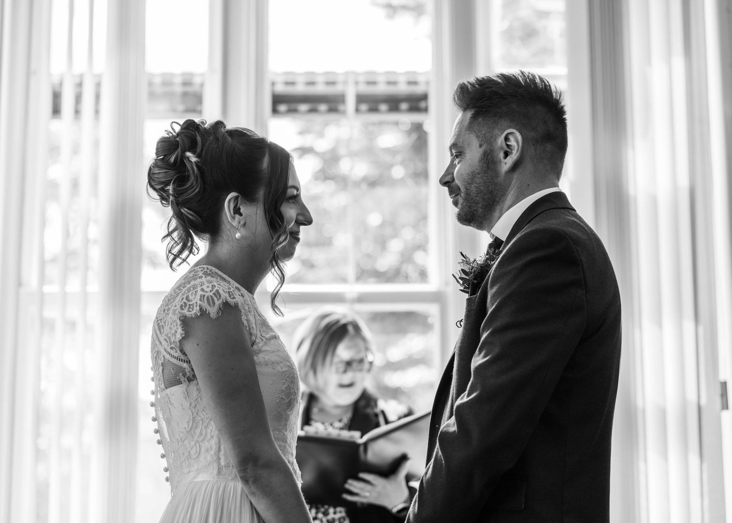 A bride and groom sharing a romantic moment during their ceremony, captured by EvieSJPhotography.