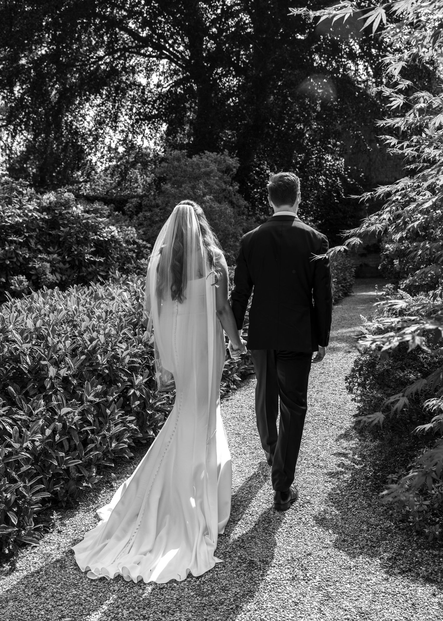 Bride and groom sharing a romantic moment on their wedding day, captured in a relaxed documentary style by EvieSJPhotography.
