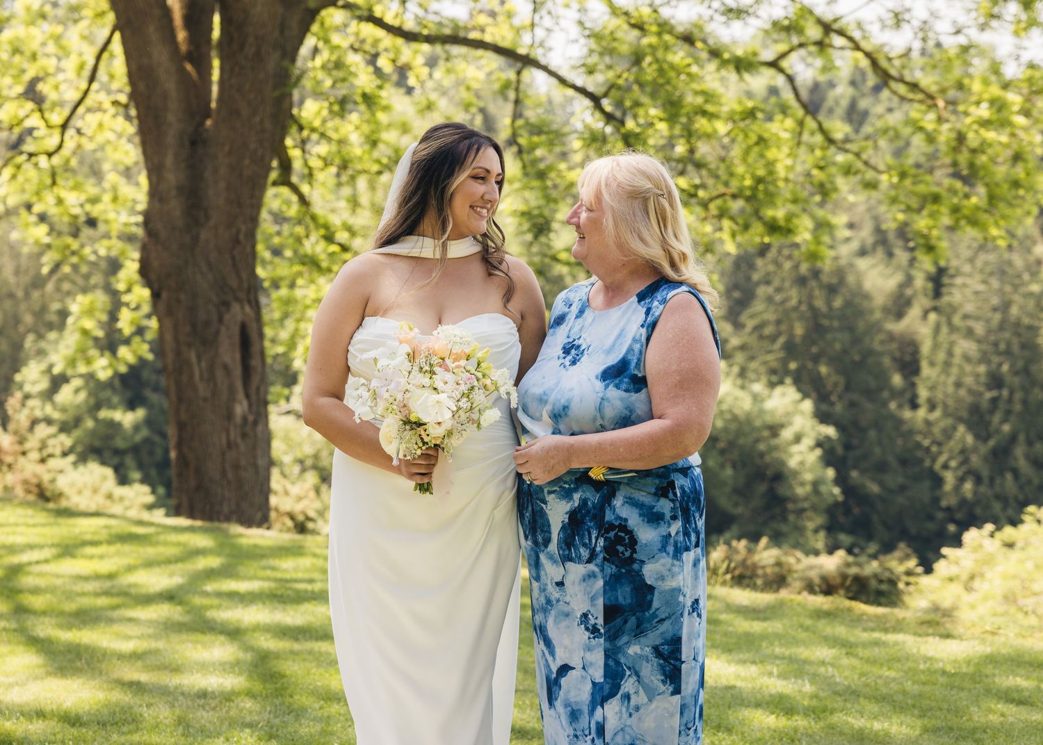 A bride and her mother enjoying a moment together, captured by EvieSJPhotography.