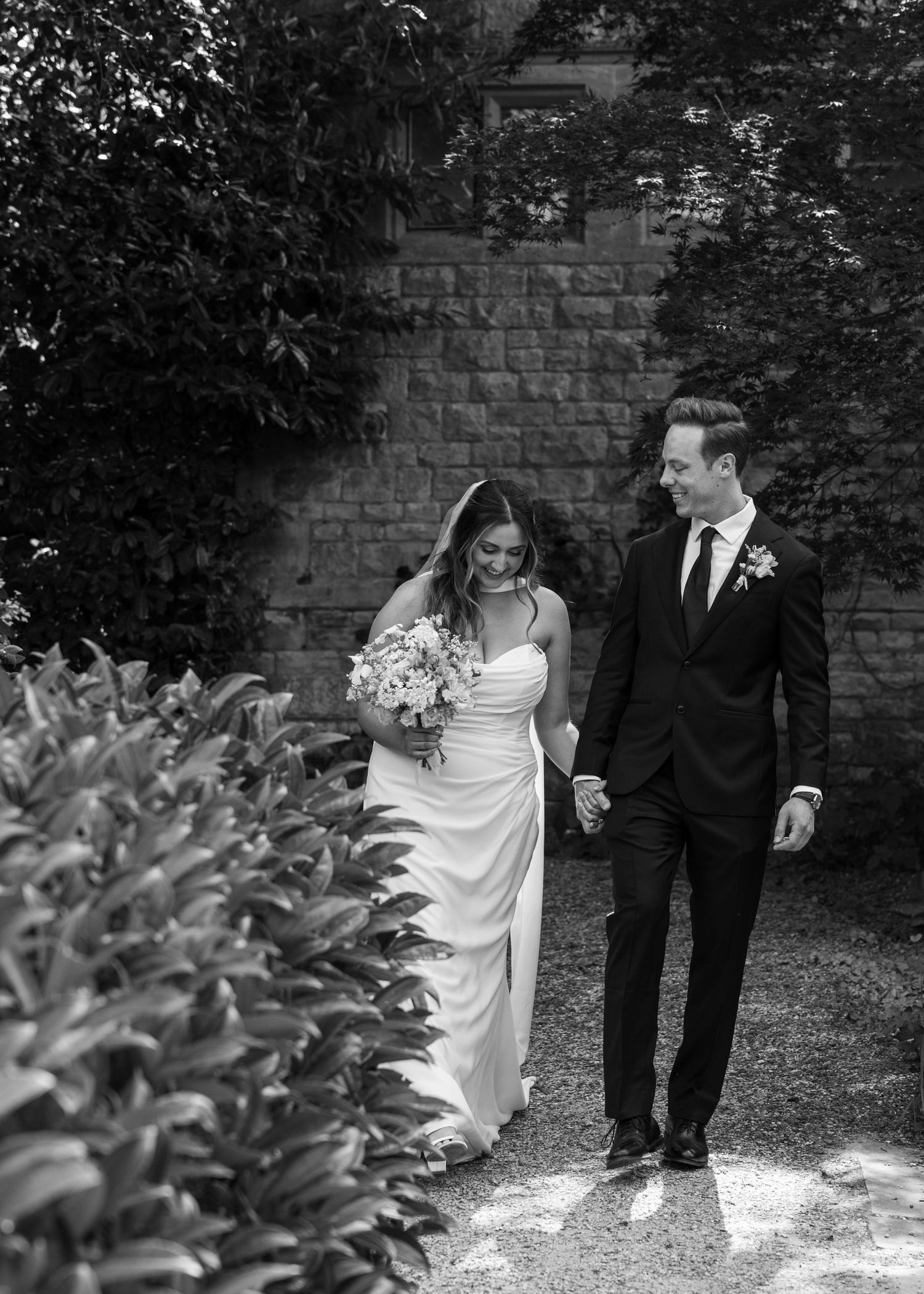 Bride and groom sharing a romantic moment on their wedding day, captured in a relaxed documentary style by EvieSJPhotography.
