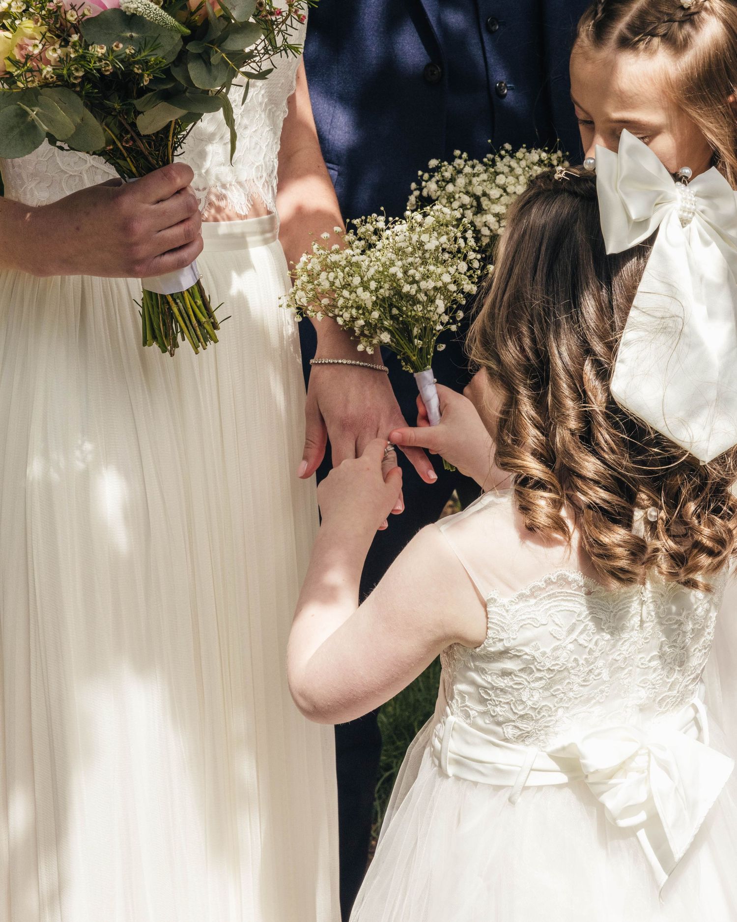 Bridesmaid admiring her mum's ring on her wedding day, captured by EvieSJPhotography.