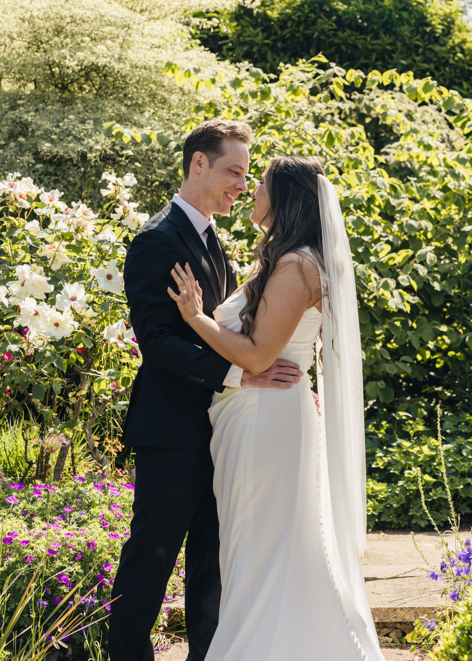 A bride and groom sharing an intimate moment together at Kiftsgate Court Gardens.