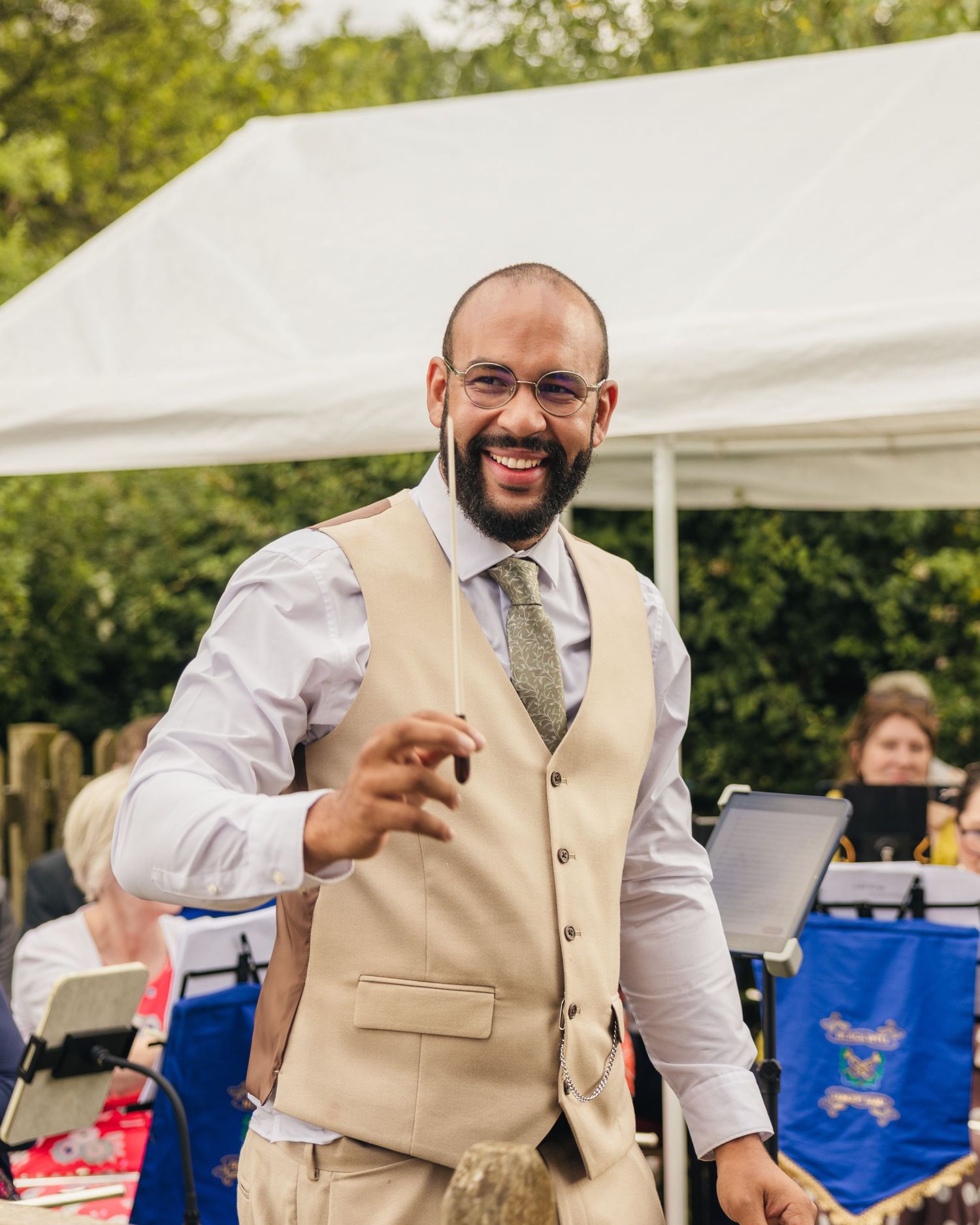 Aaron having a go at conducting an orchestra at Rock Village Hall.