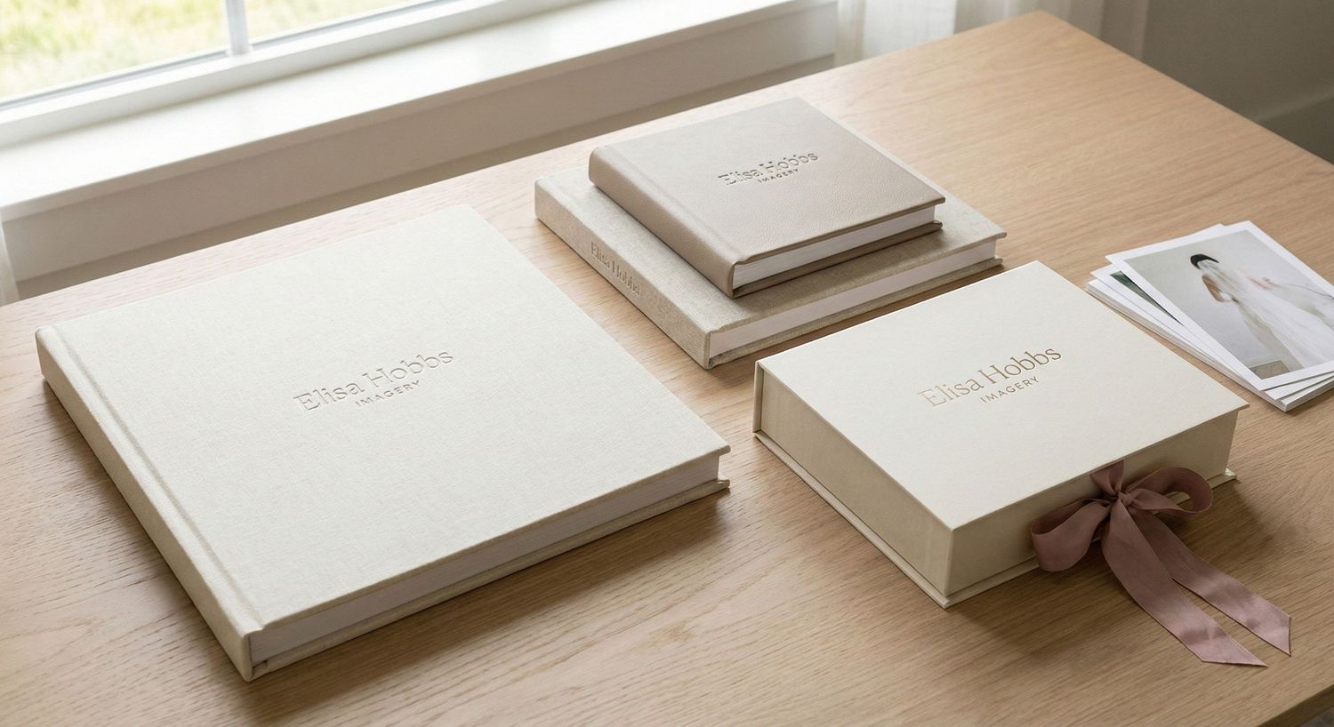 White gift boxes with elegant satin ribbon bows arranged in a row on a light surface.