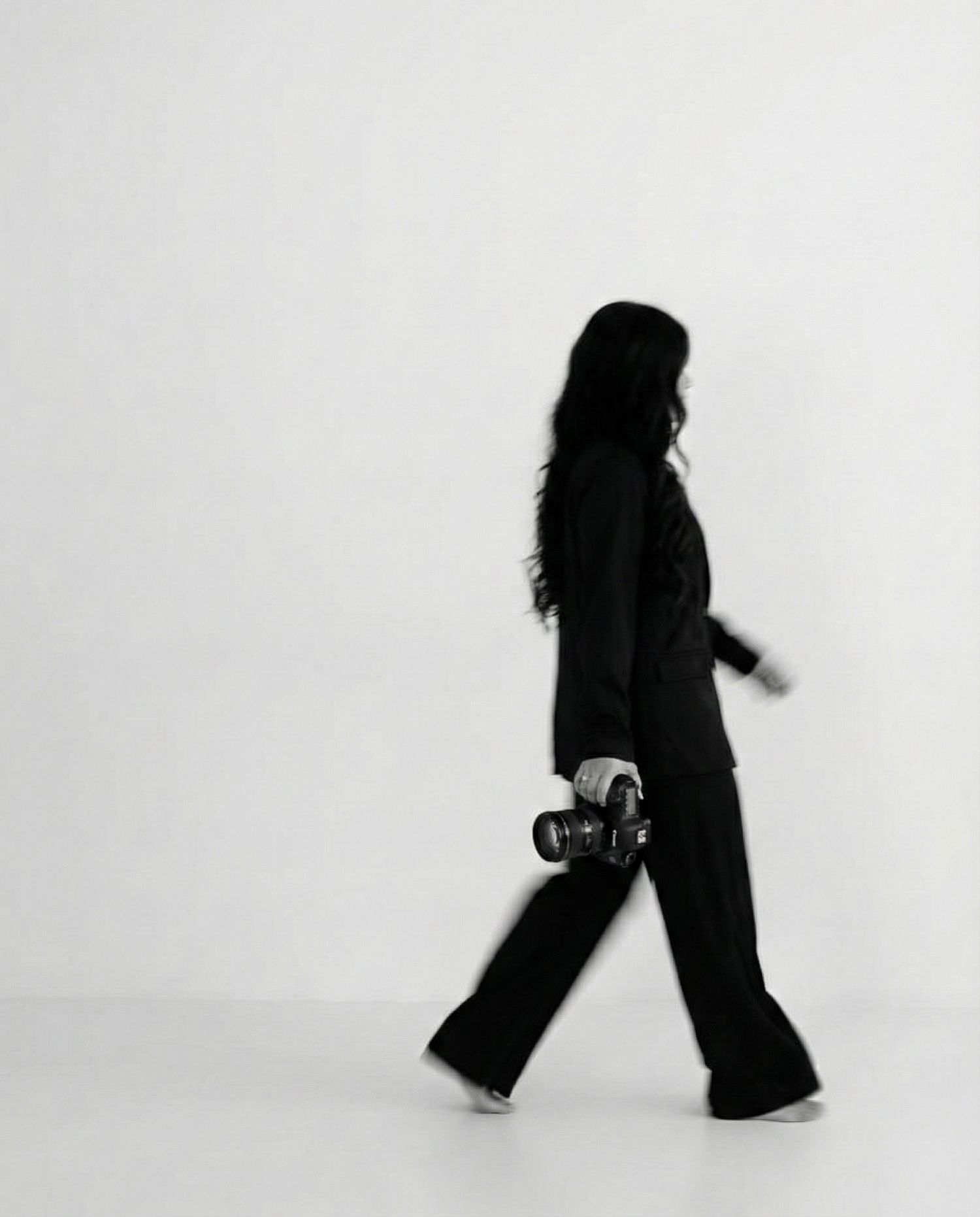 Elisa Hobbs Imagery walking across a photography studio backdrop in Austin Texas