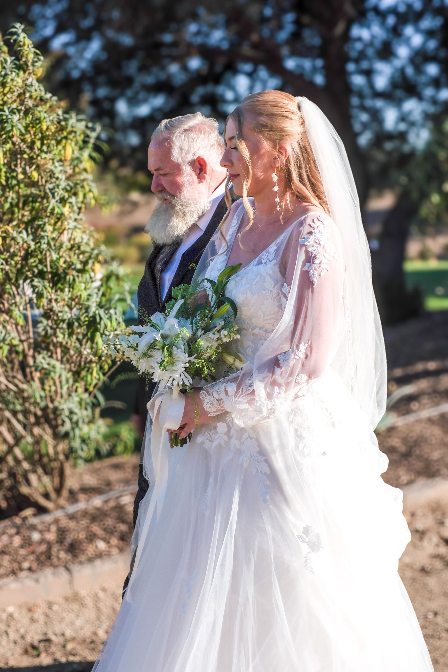 A romantic wedding couple shares tender moments outdoors in a series of intimate portraits at sunset.
