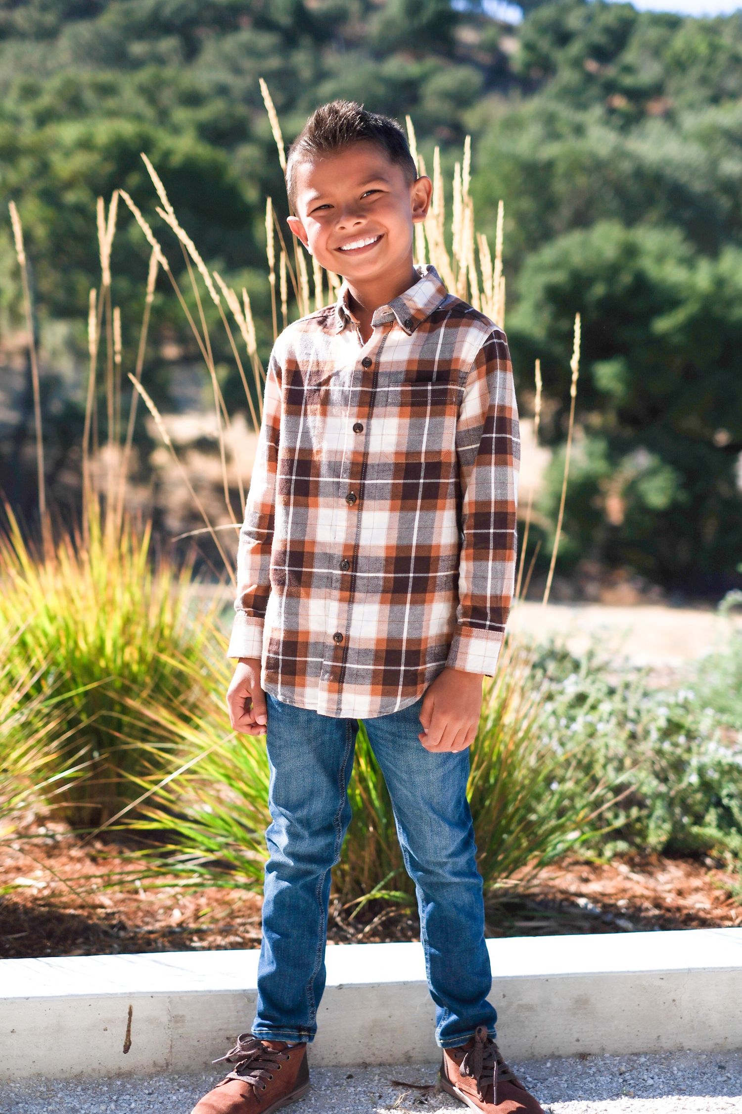 A series of photos showing a plaid shirt and jeans outfit against an outdoor garden backdrop with ornamental grasses.