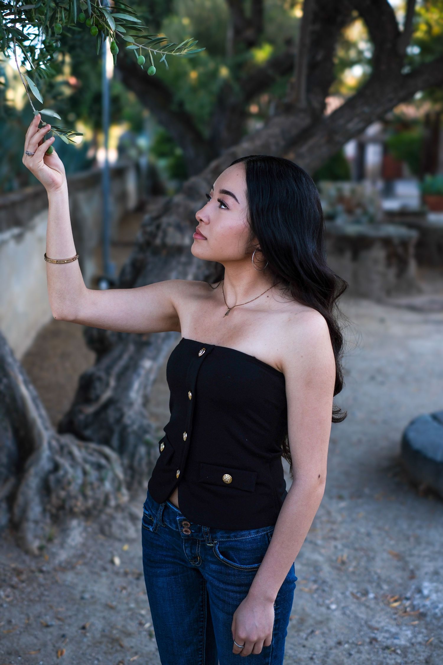 Expressive outdoor photography with dramatic poses against a garden background.