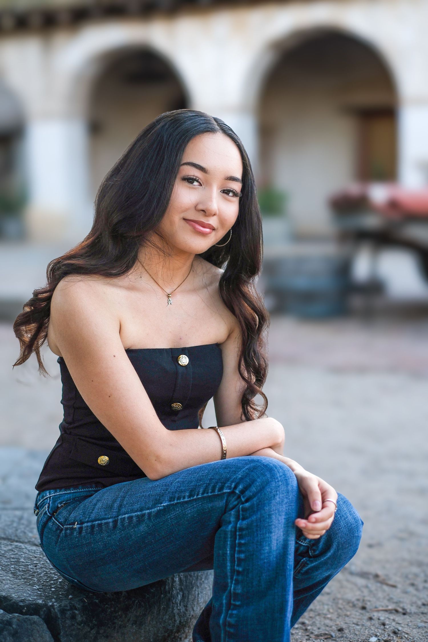 Casual portrait session against white mission architecture featuring modern street style.