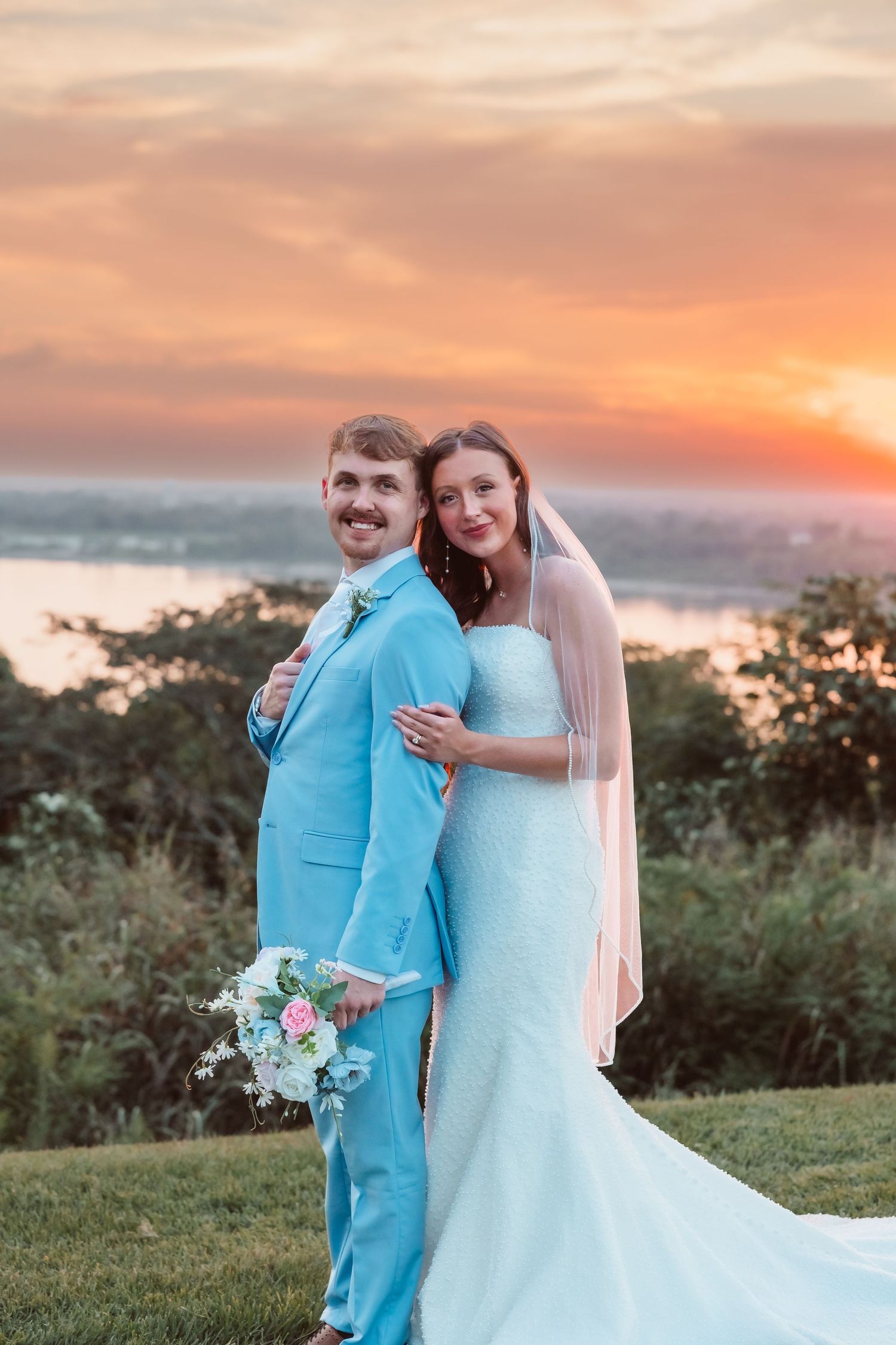 Bride and groom sunset portraits by the Mississippi River