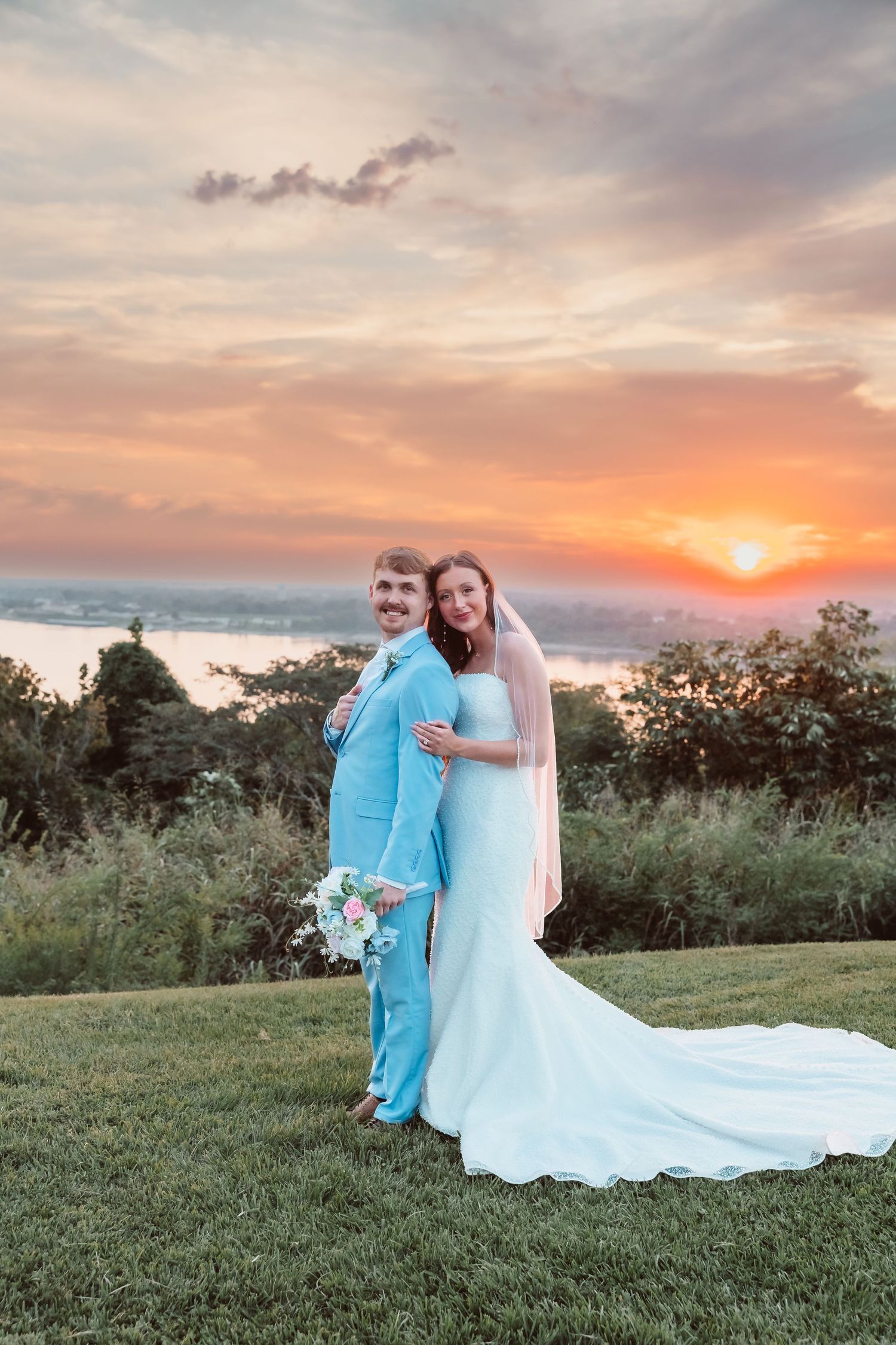 Wedding couples portraits captured during golden hour on the Mississippi River