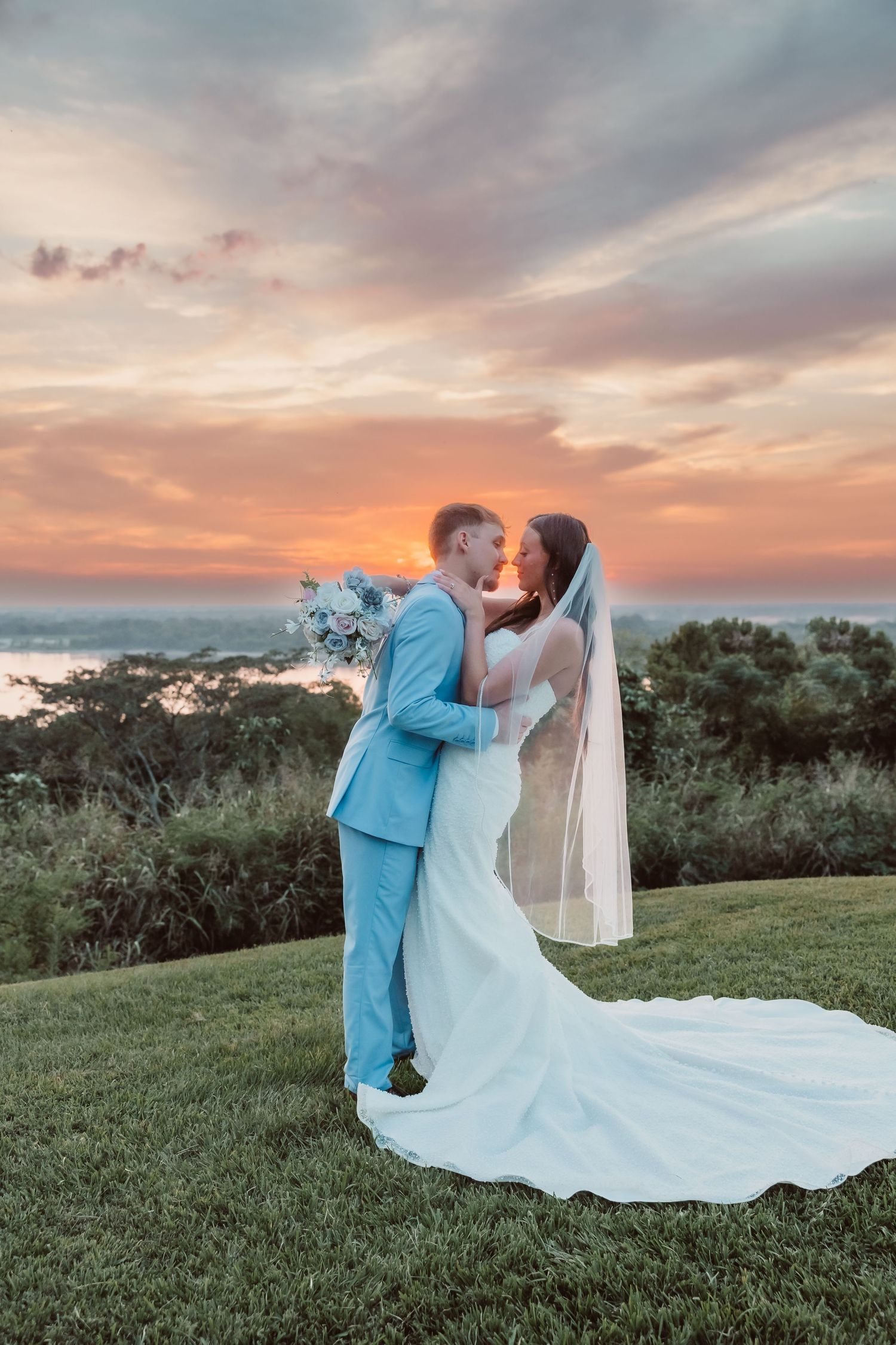 Bride and groom couples portraits at sunset overlooking the Mississippi River