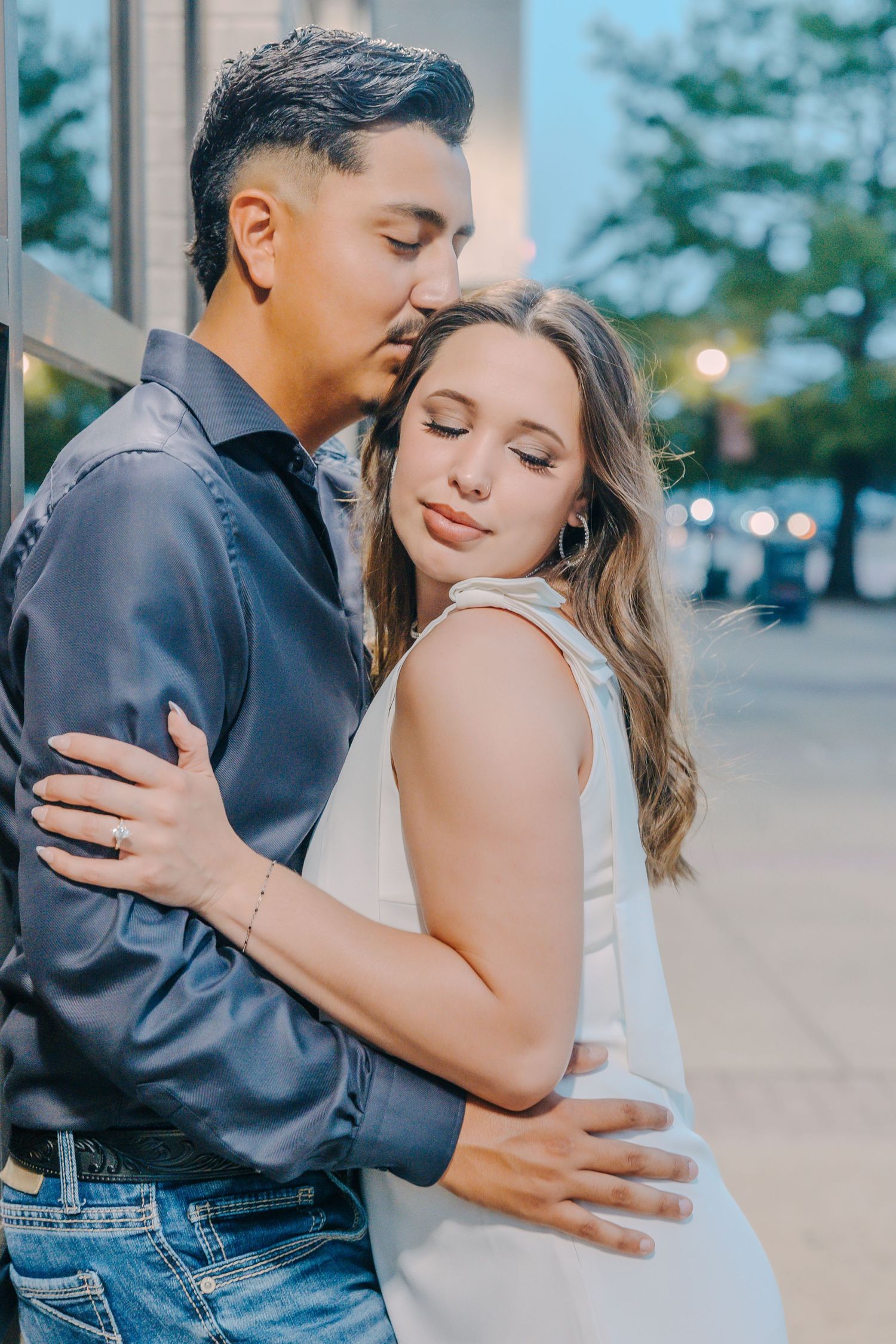 A romantic couple shares tender embraces in a series of intimate outdoor portrait photographs.