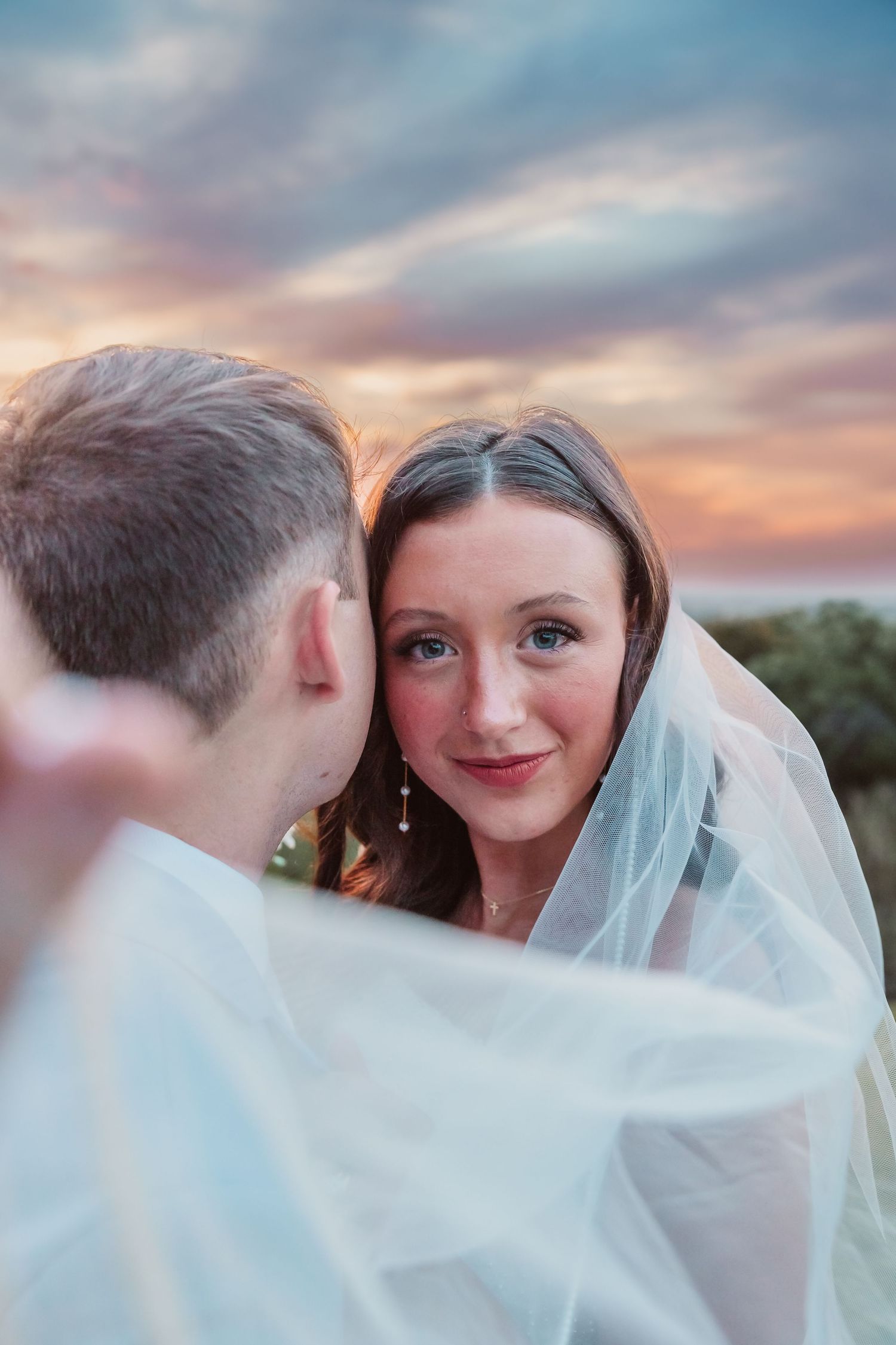 Glowing sunset wedding portraits overlooking the Mississippi River