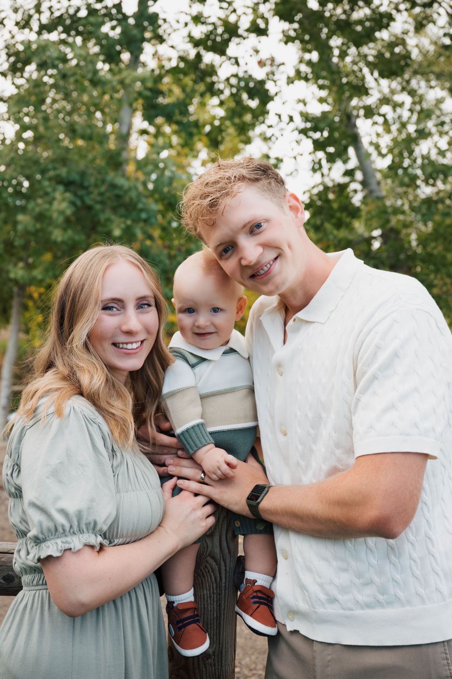 Family shares joyful candid moments together during outdoor portrait session.