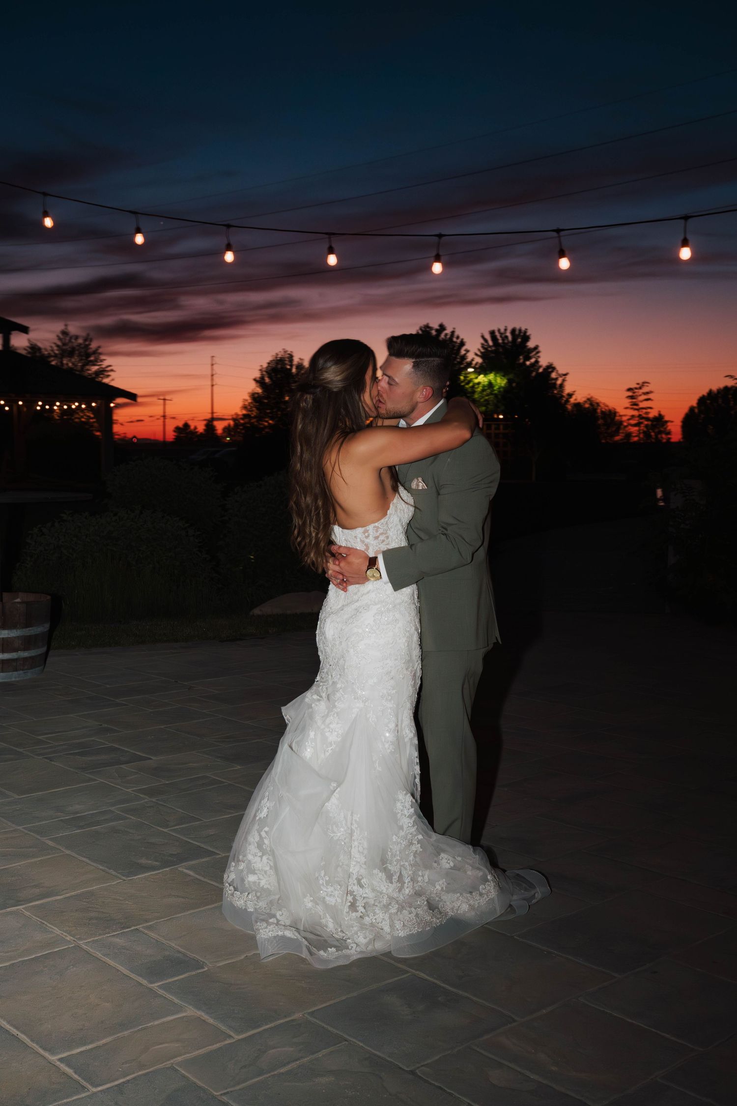 Bride and groom sharing a final dance outside at sunset during their wedding at Mint Barrel Barn in Nampa, Idaho.
