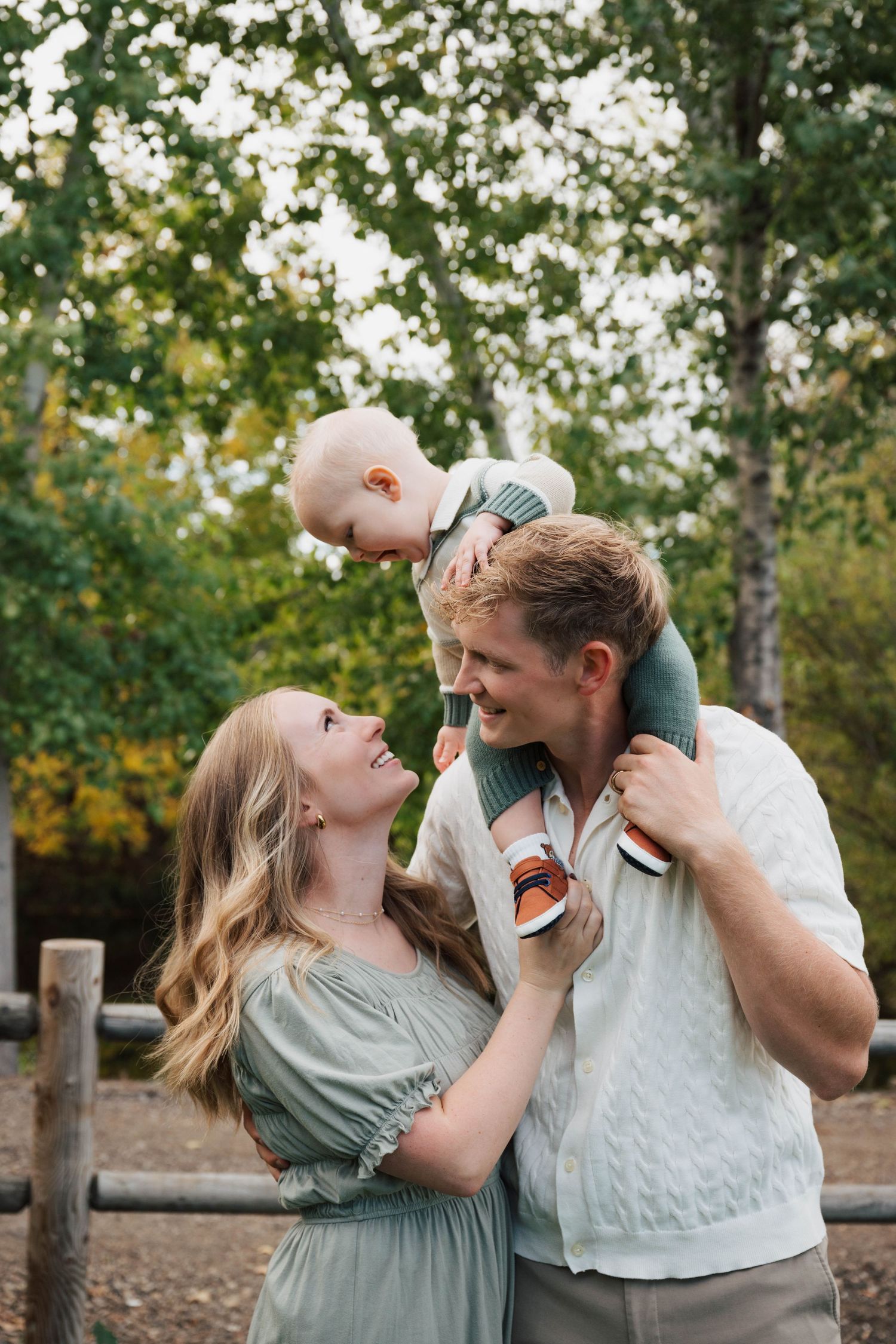 Couple shares playful moments together during outdoor photo session.