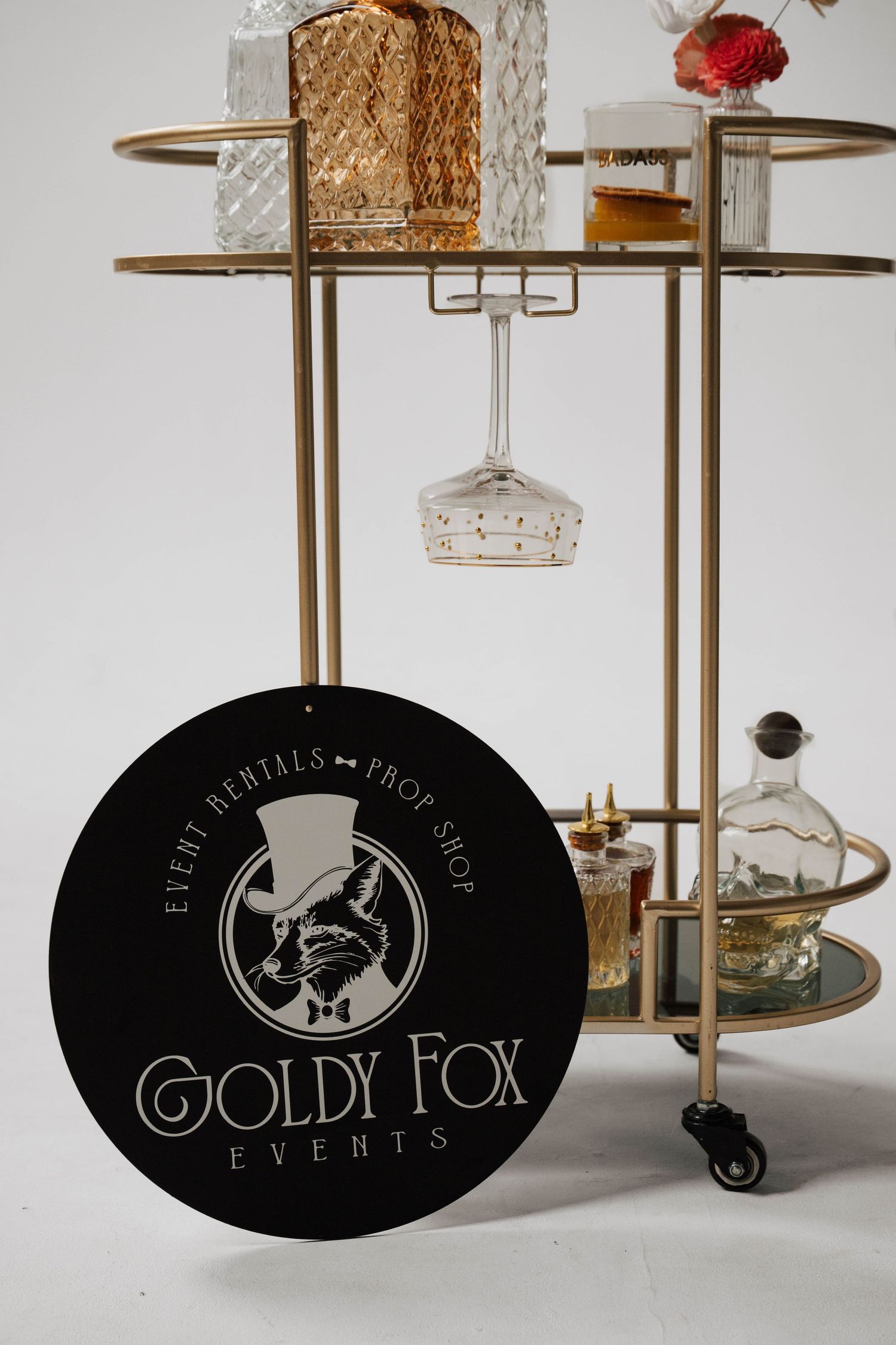 Gold Fox Events logo and branding displayed on elegant bar cart setup.