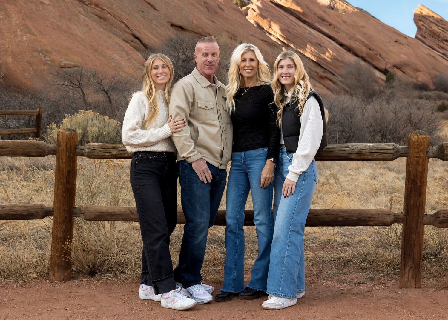 Wild Light Studio family portrait at Red Rocks Amphitheater in Colorado taken during winter golden hour with dramatic sandstone formations.