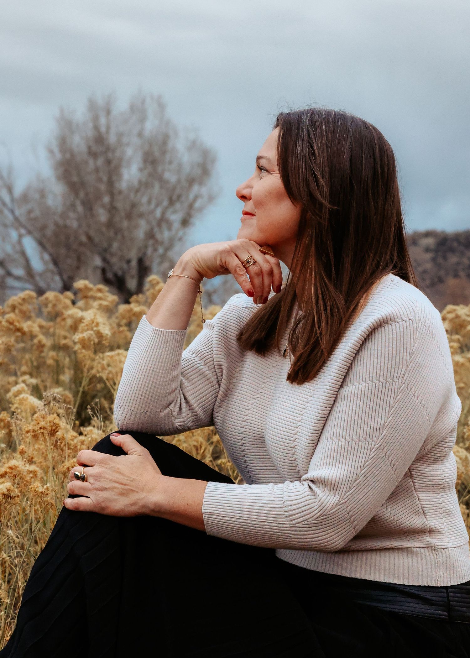Wild Light Studio portrait of woman at Red Rocks Amphitheater in Morrison, Colorado taken during winter with rabbit brush and moody skies.