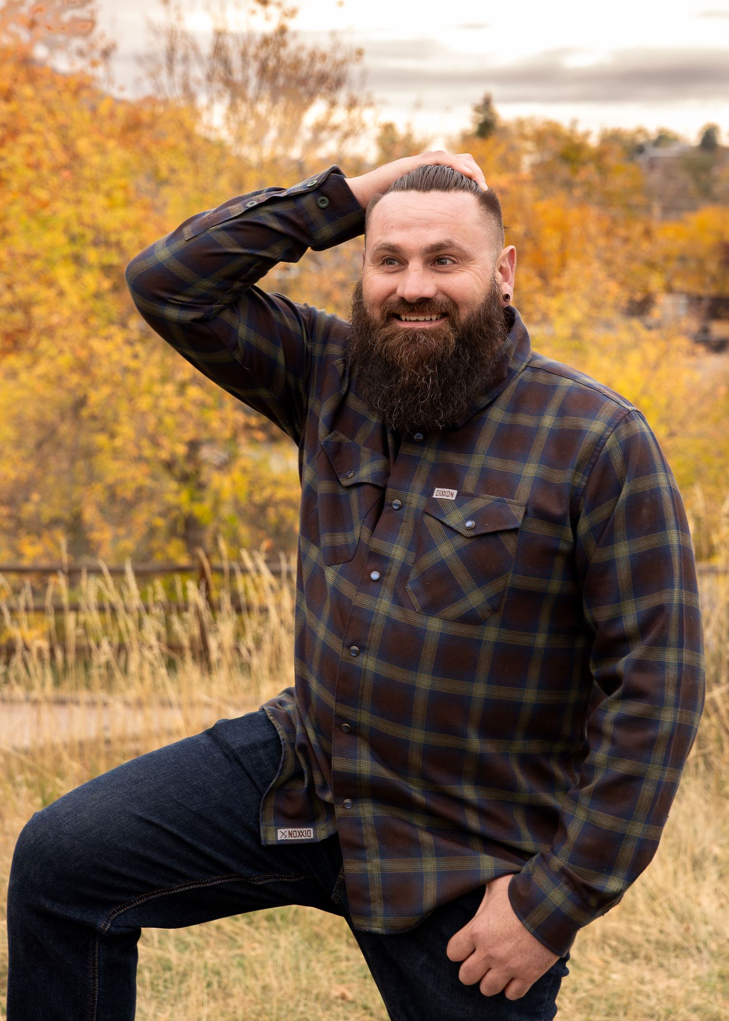 Canid portrait of man in Golden, CO with fall foliage in the background by Wild Light Studio a photographer in Arvada, Colorado.