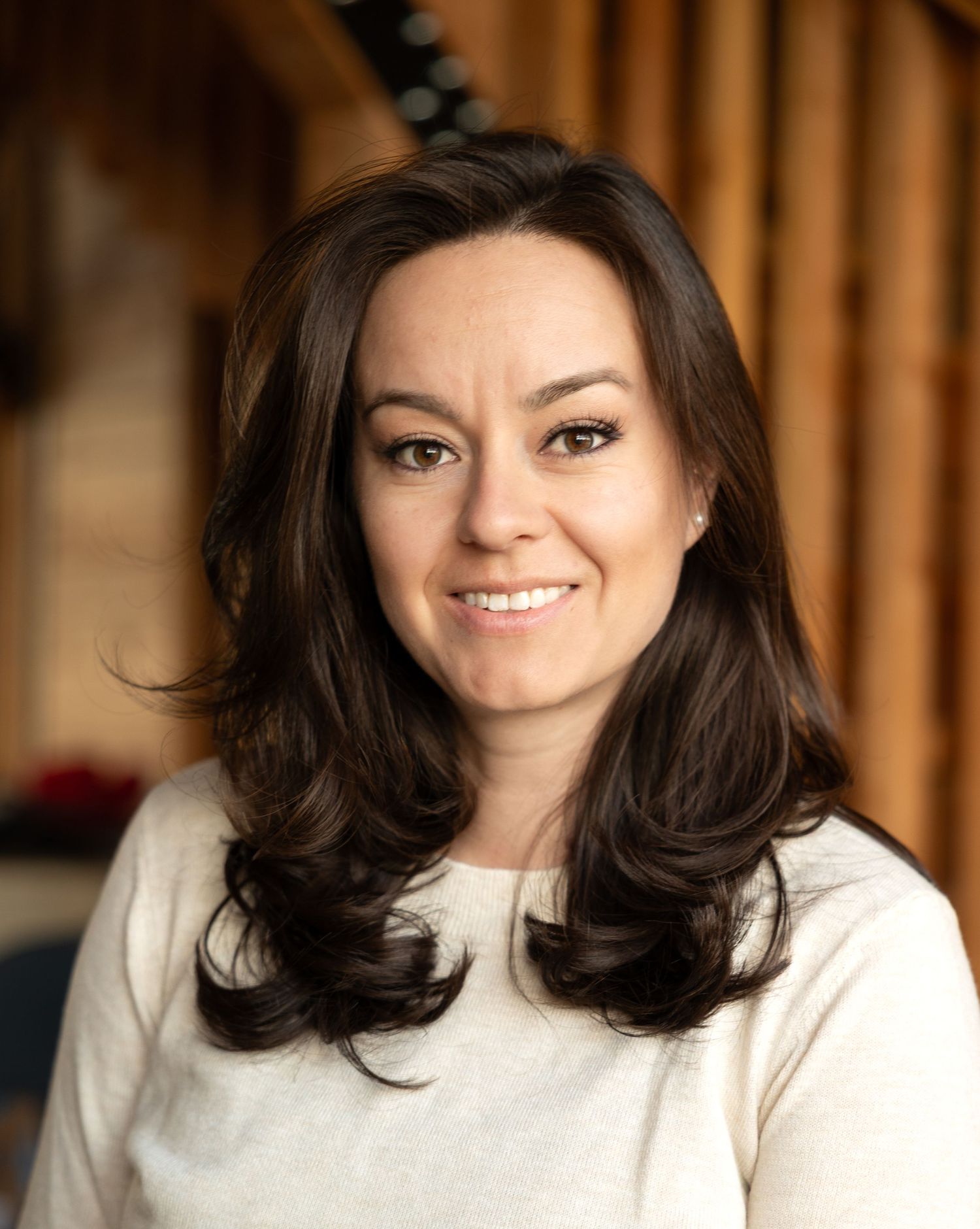 Corporate headshot with photographer in Arvada CO for resume and Instagram profile picture. Indoor photography using natural warm lighting.