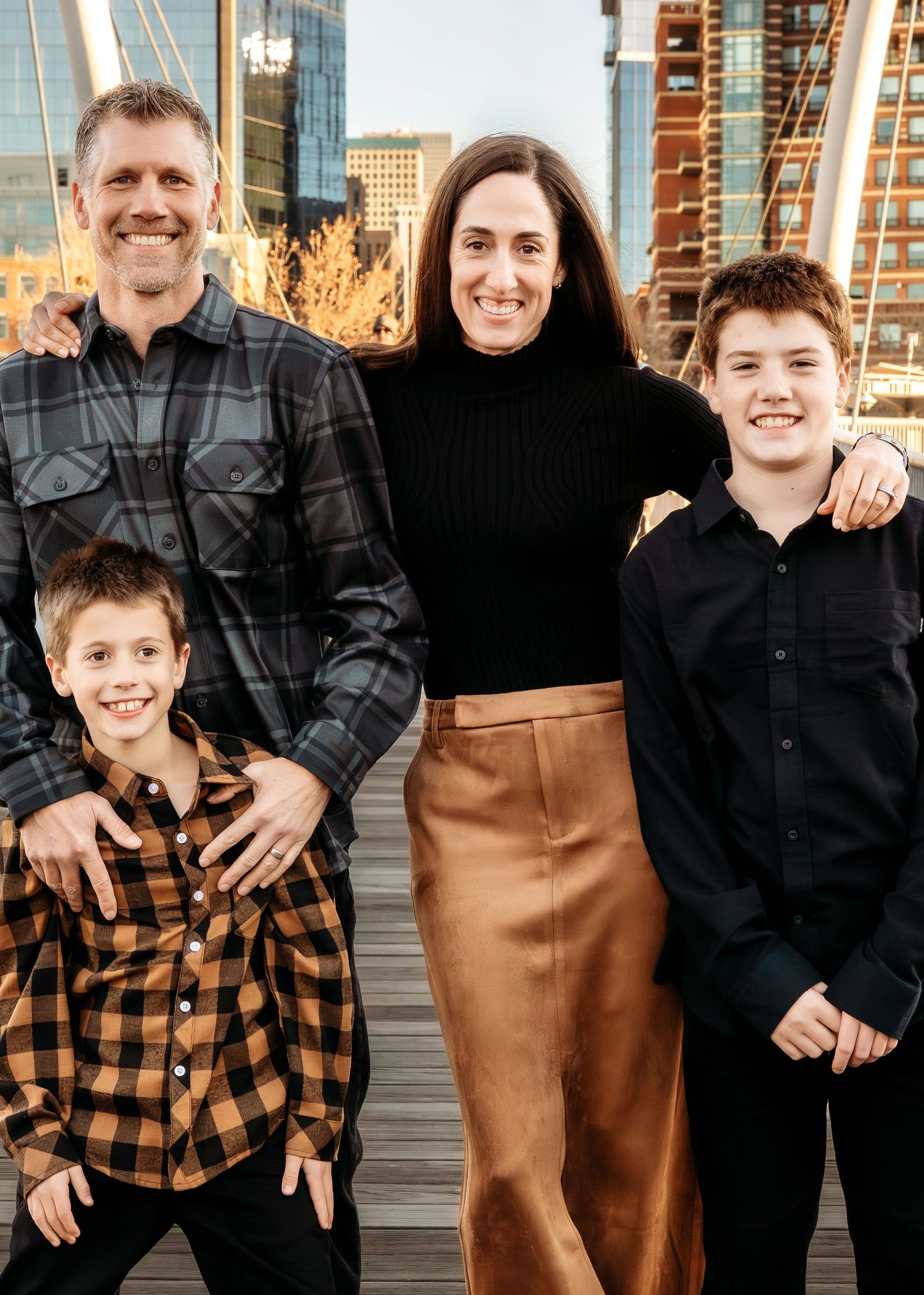 Family photograph in downtown Denver by Wild Light Studio featuring natural light and city scape architecture.