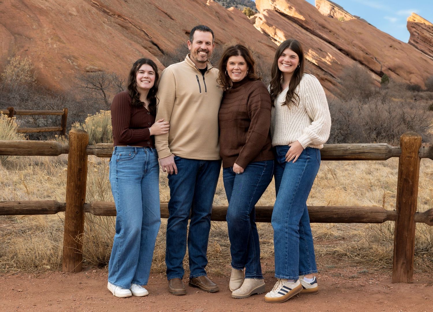 Wild Light Studio family portrait at Red Rocks Amphitheater in Colorado taken during winter golden hour with dramatic sandstone formations.
