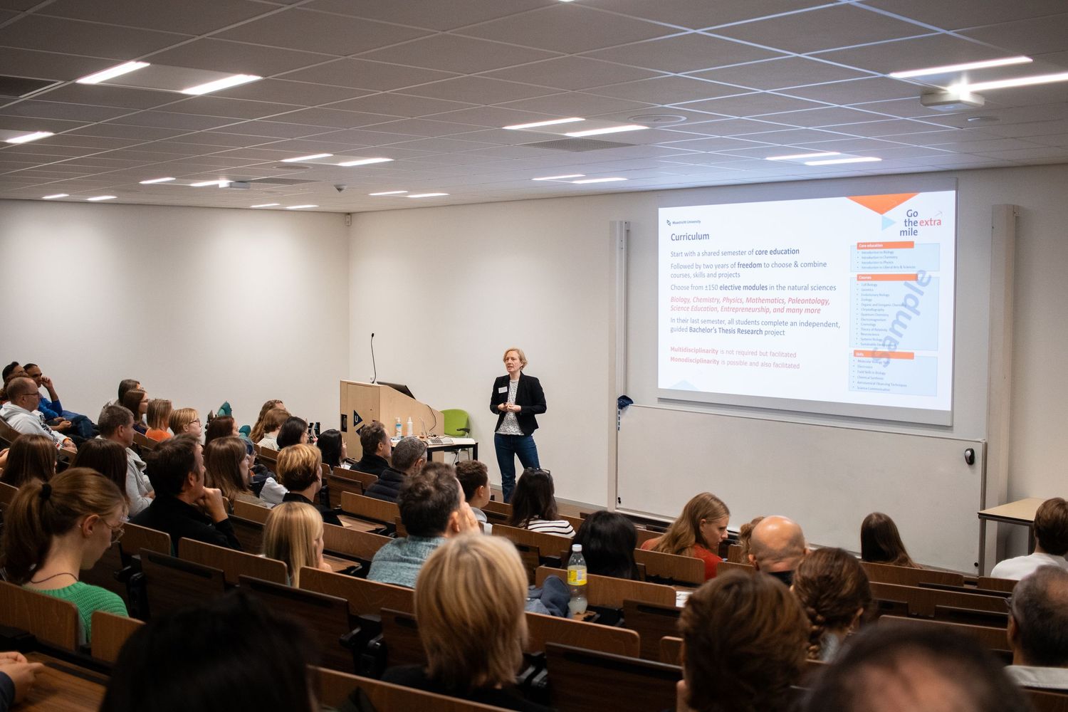 Professor delivers a lecture to a full auditorium at Maastricht University open day information session.