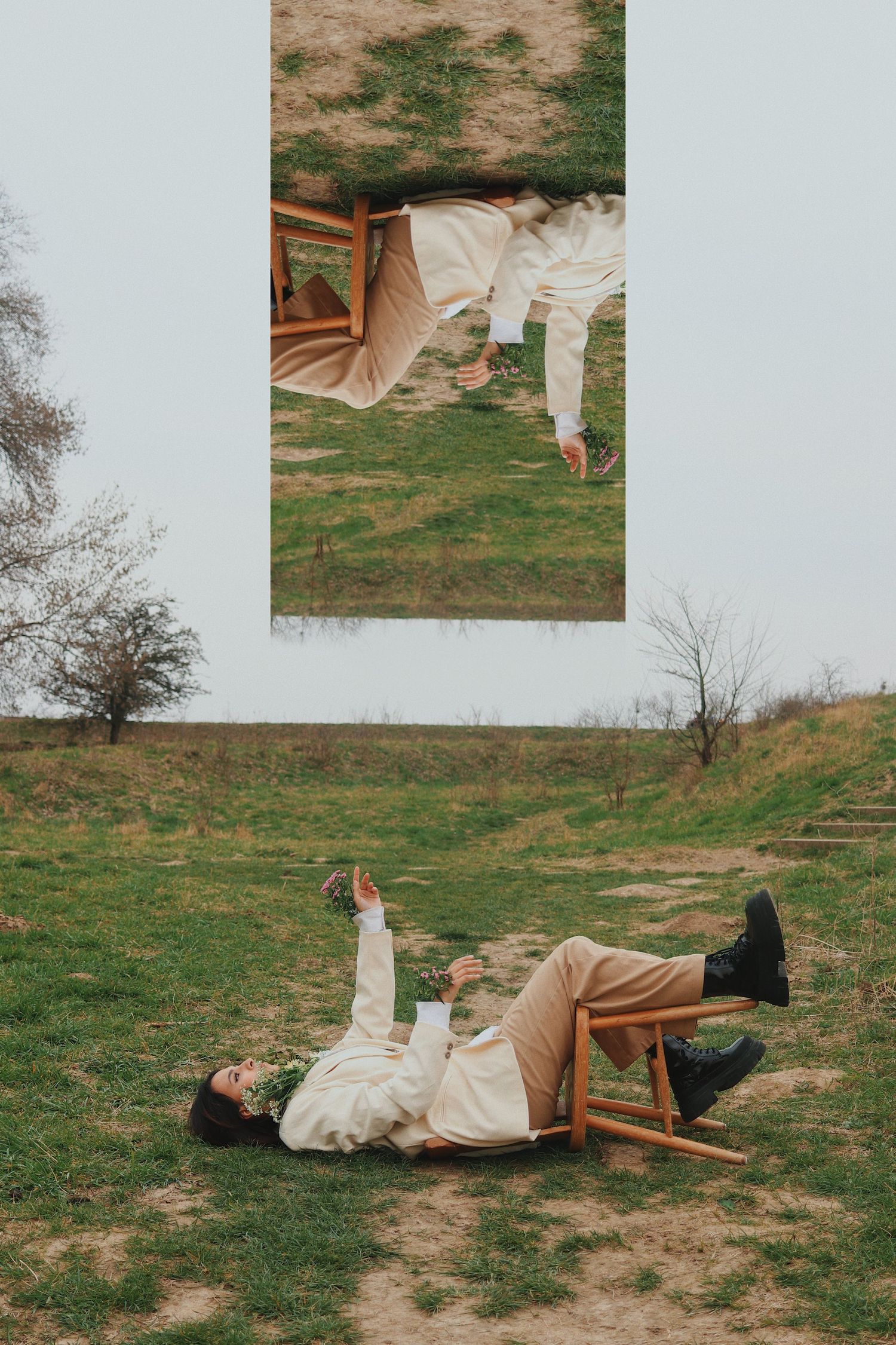 Creative double exposure of woman lying on grass holding flowers with inverted mirror reflection above.