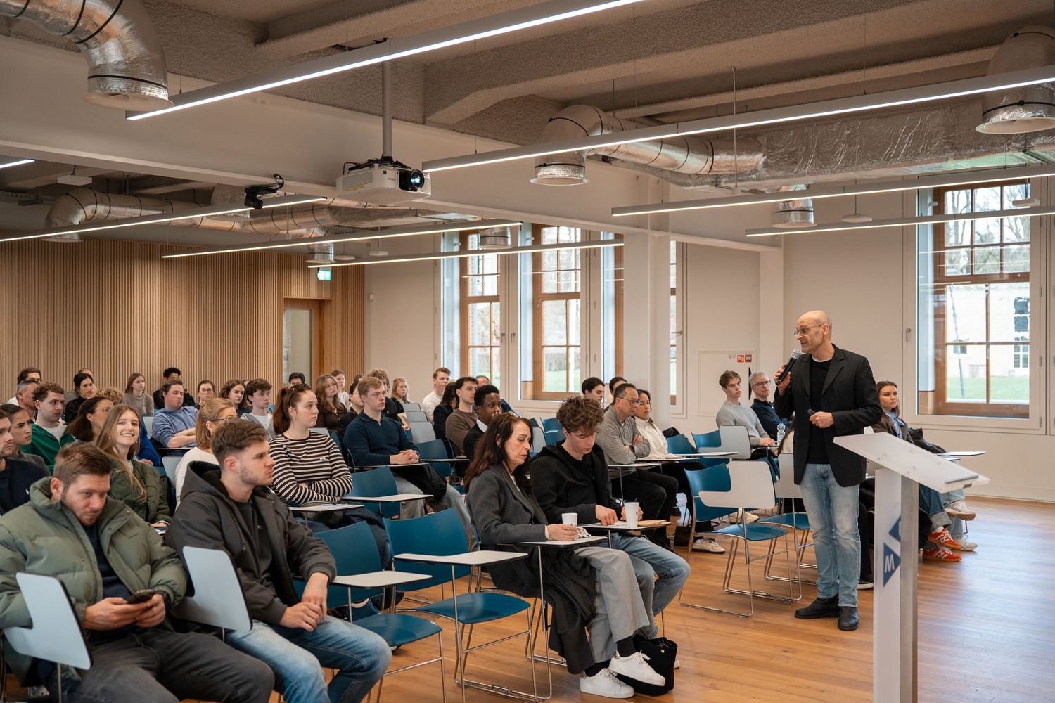 Professor lectures to a full classroom of students at a Maastricht University Open Day session.