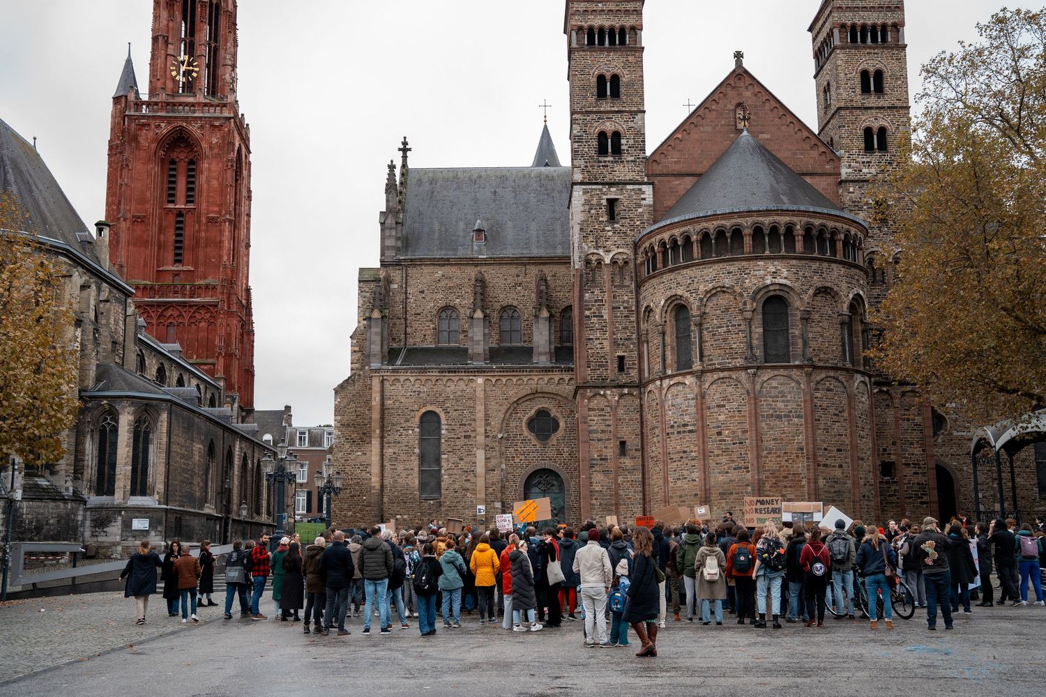 Large group of people assembled in front of the Basilica of Saint Servatius in Maastricht, Netherlands.