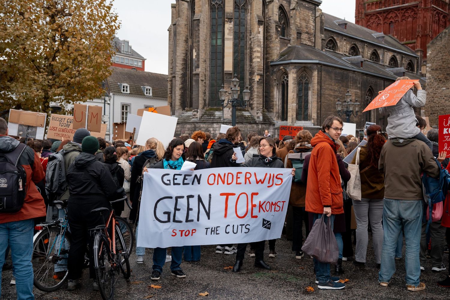 Protesters hold banner reading Geen Onderwijs Geen Toekomst Stop The Cuts at education rally.