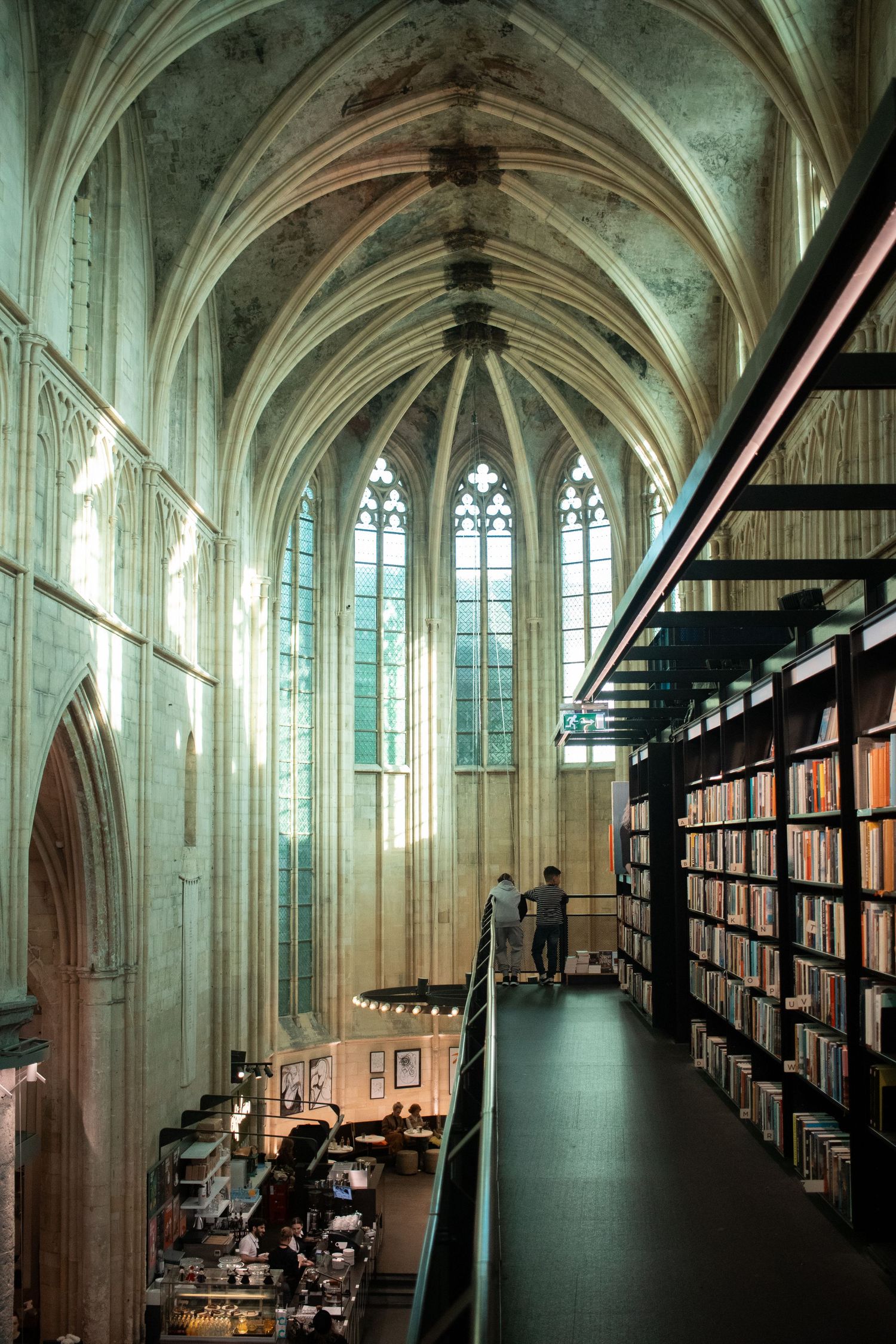 Interior of Boekhandel Dominicanen, a stunning bookstore inside a Gothic medieval church with vaulted ceilings in Maastricht.