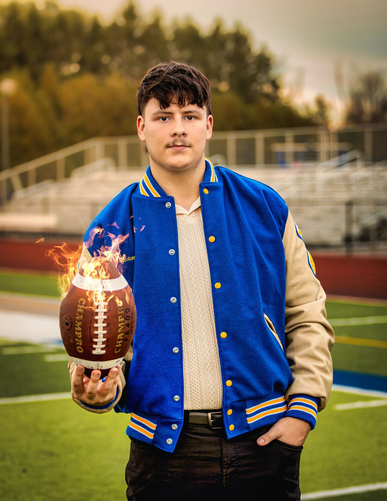 Concordia University senior photography. Teen boy with football on fire, creating dramatic, edgy, and unforgettable high school portraits.