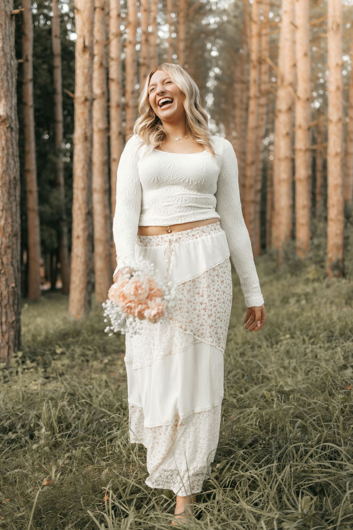 Senior session with girl in white shirt and long skirt, holding flowers. Natural, candid, and heartwarming outdoor high school portraits.