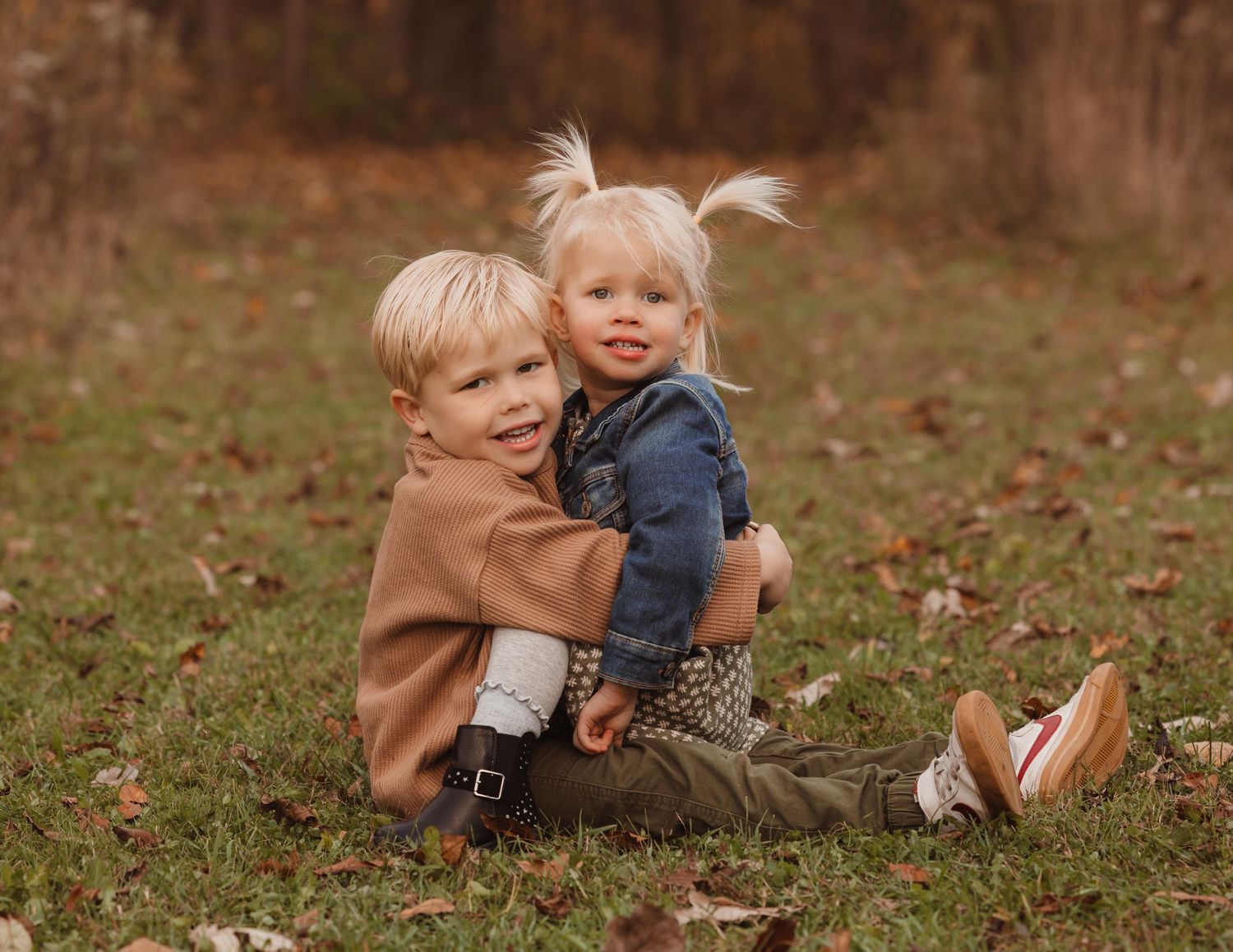 Siblings hugging at Menomonee Park, Waukesha during golden hour. Warm, timeless portrait capturing love, connection, and joy.