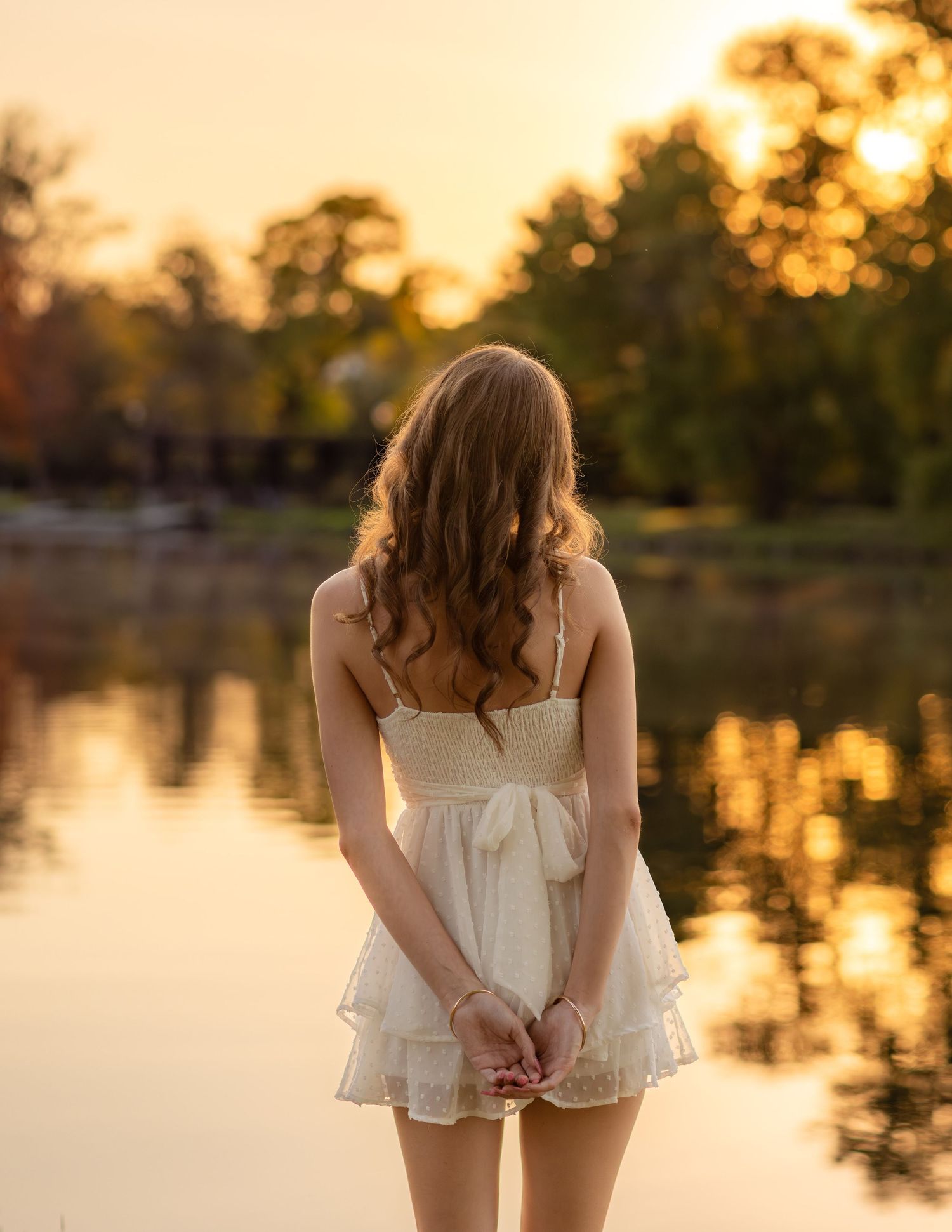 Golden hour senior session at Frame Park, Waukesha. Teen gazing at the Fox River, captured in warm, cinematic, and natural portraits.