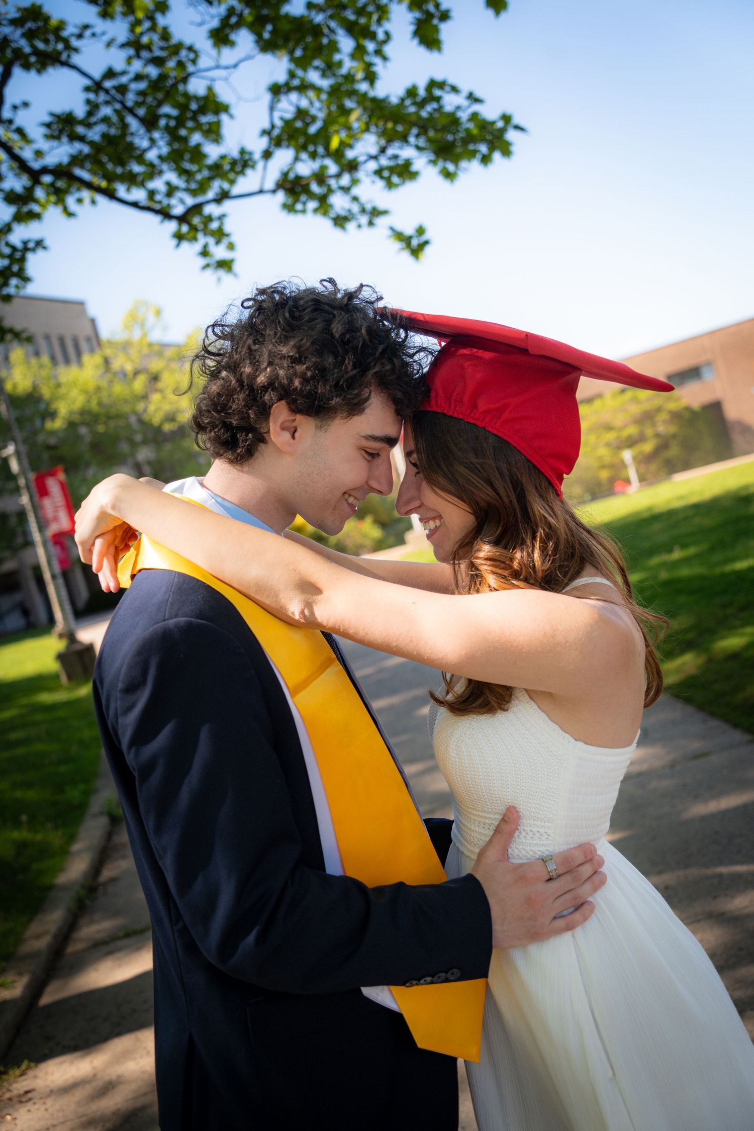 Couple embracing outdoors on a sunny spring day.