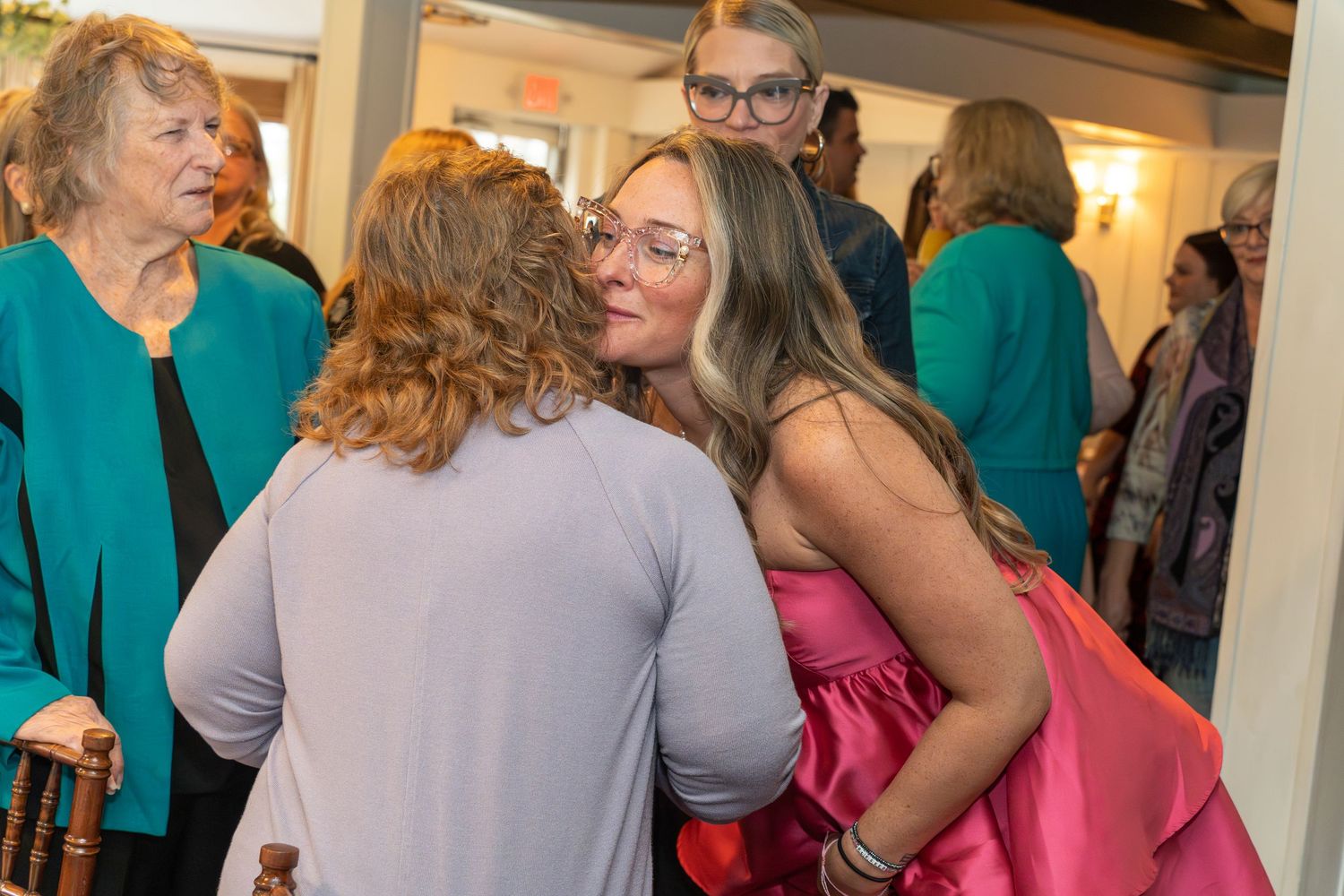 People mingle and socialize at an indoor celebration event.