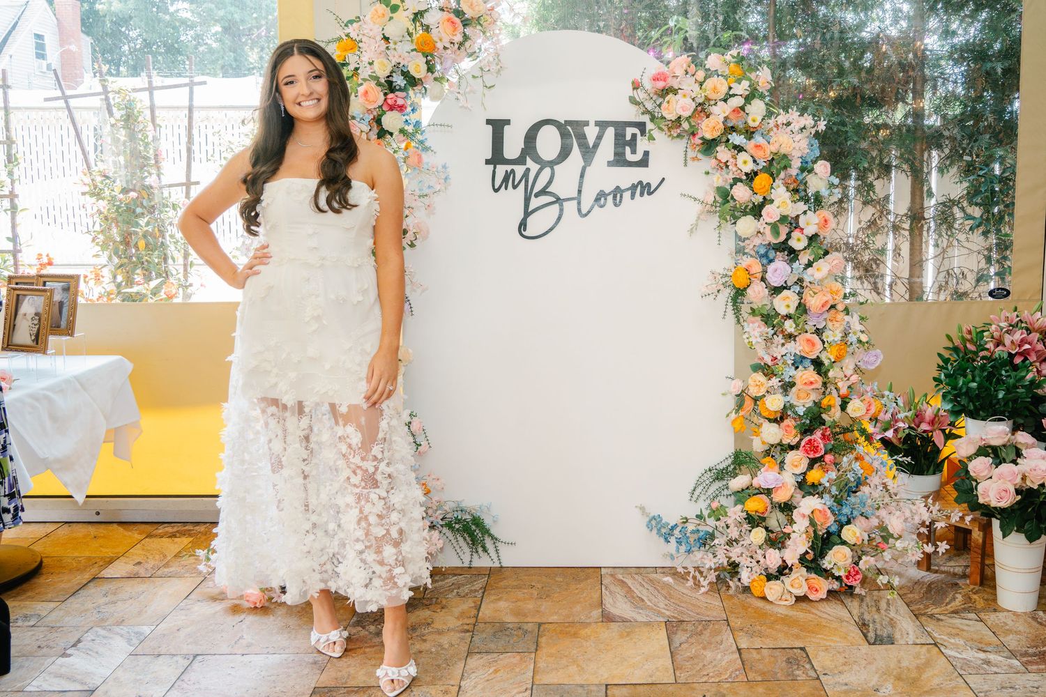 Floral wall display with 'LOVE' text creates a romantic photo backdrop.